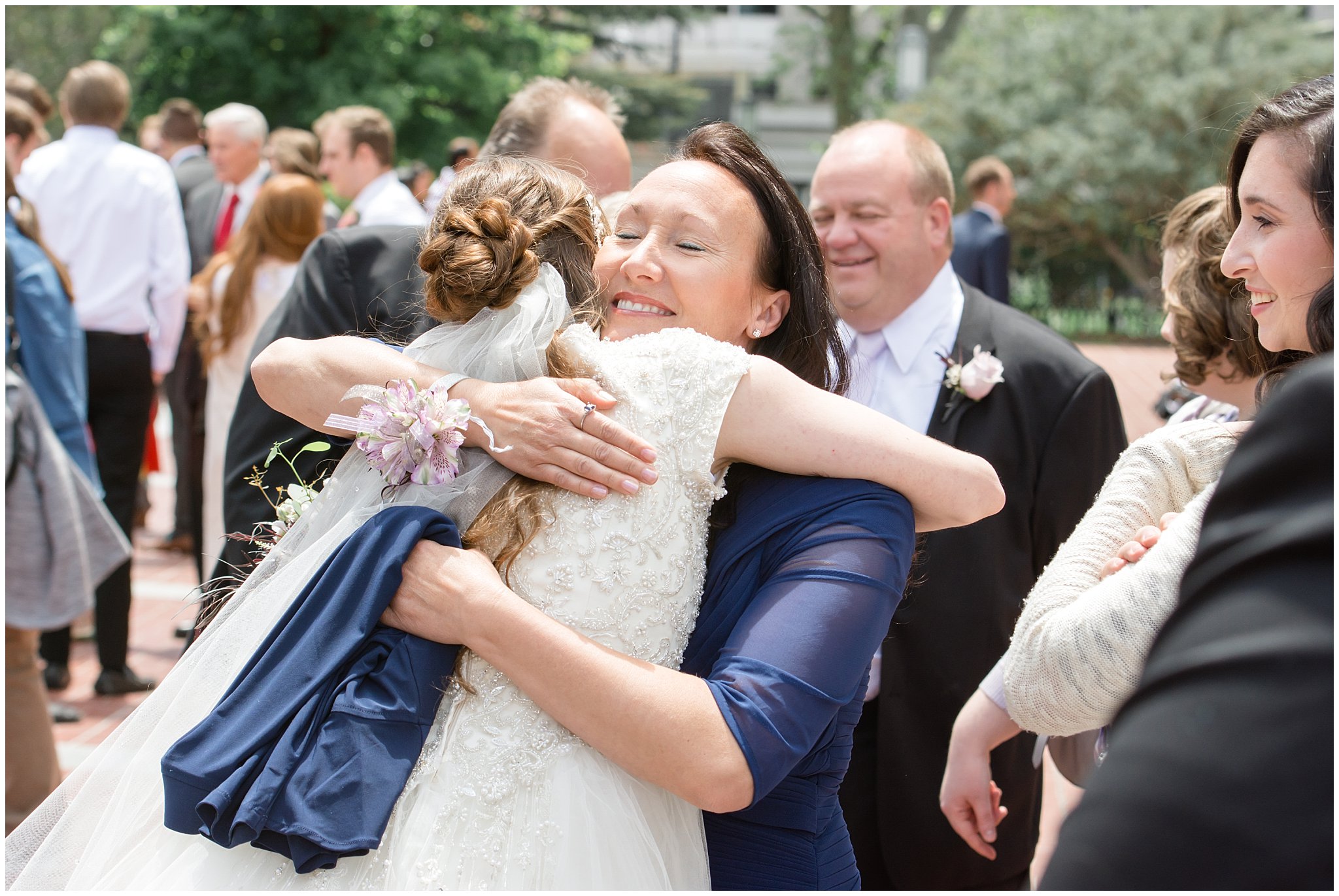 Bride hugs her mom during exit from Salt Lake Temple | Utah Wedding Photography | Candid wedding pictures | Jessie and Dallin Photography