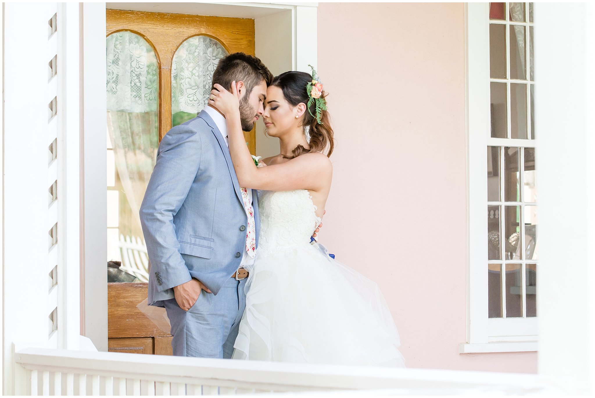 Couple embracing on doorstep of garden wedding | This is the Place Heritage Park | Green and Pink Garden Wedding | Jessie and Dallin Photography