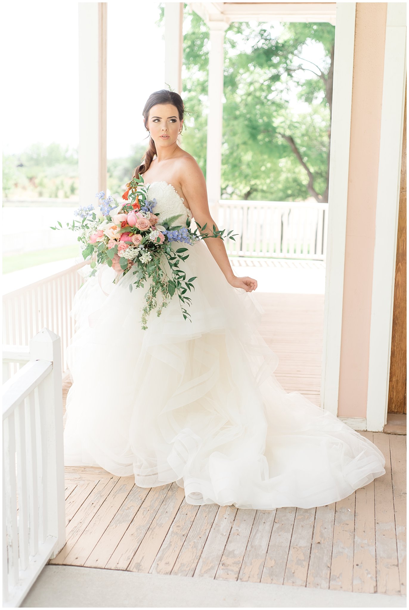 Bride in elegant dress on porch | This is the Place Heritage Park | Green and Pink Garden Wedding | Jessie and Dallin Photography