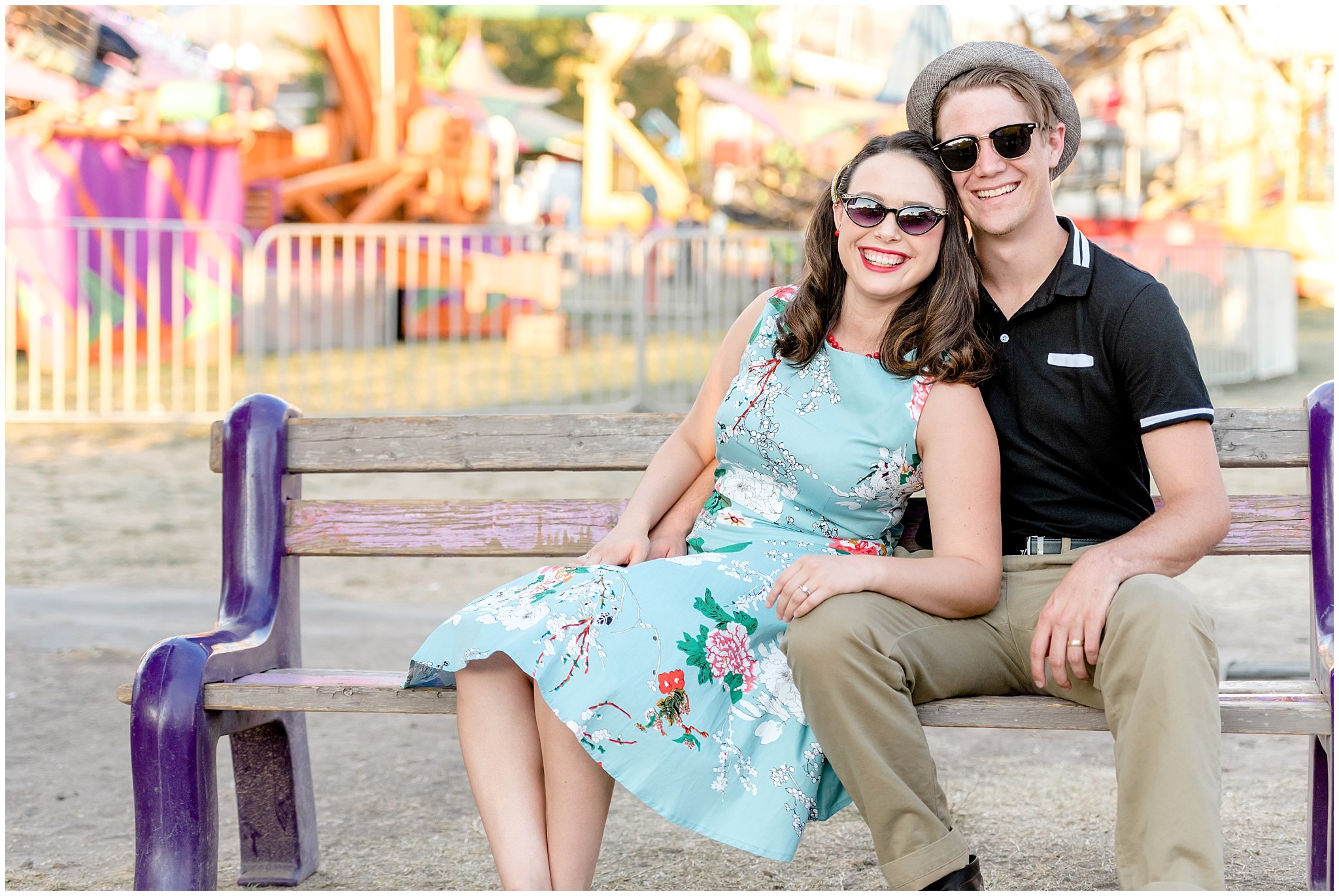 Couple sits on a bench at the carnival in front of the Ferris Wheel for their summer engagement session in Utah | Jessie and Dallin Photography | Utah Wedding Photographers