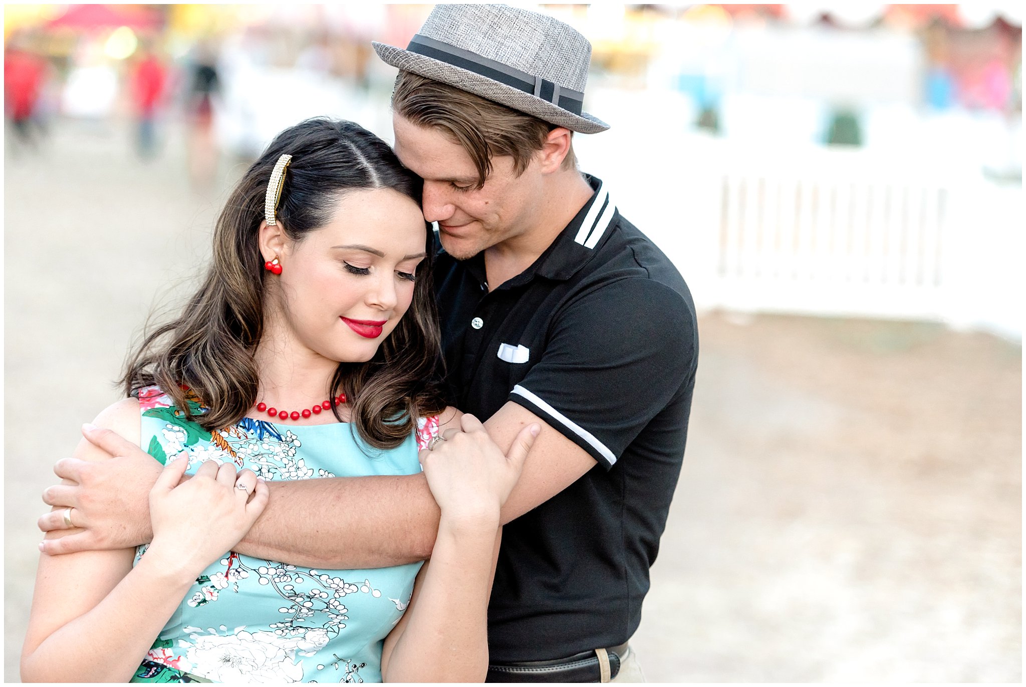 Couple cuddles close at the state fair during their engagement session in Utah | Jessie and Dallin Photography | Utah Wedding Photographers