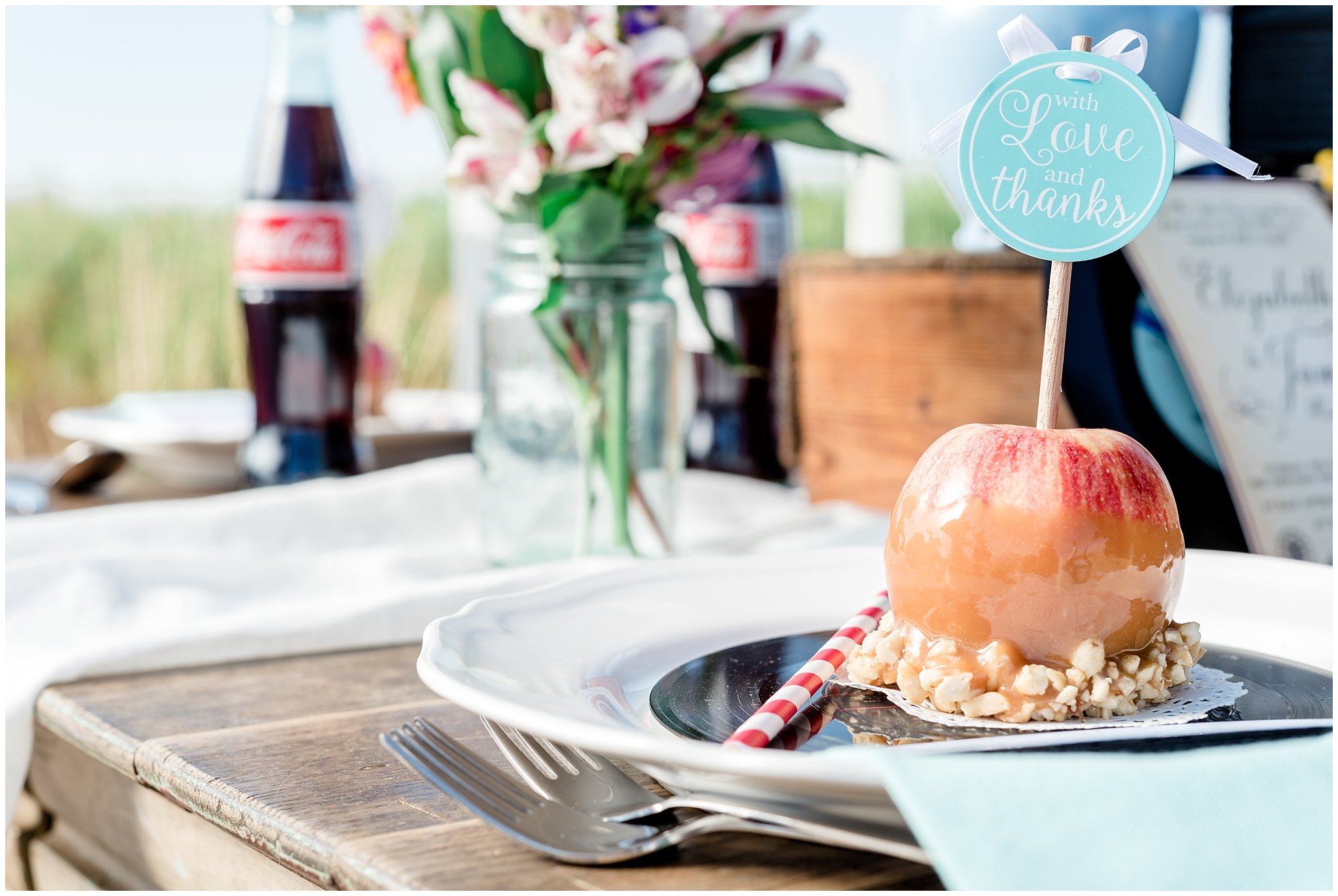 Caramel apples, records, Coca-cola bottles and flowers on a farmhouse table in Utah | Jessie and Dallin Photography | Utah Wedding Photographers