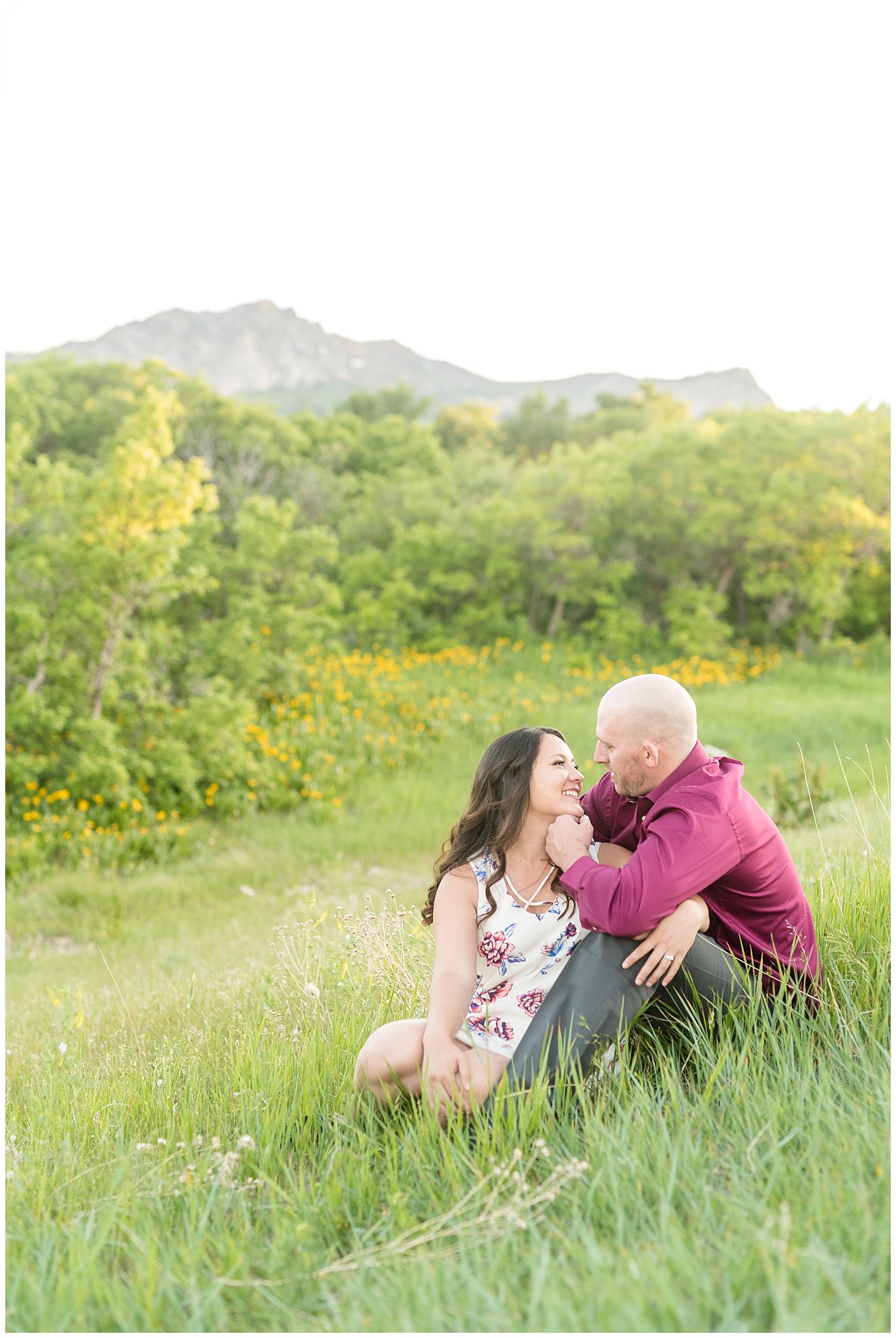 Couple's engagement session with mountains in the background and wildflowers | Snowbasin Utah Engagements