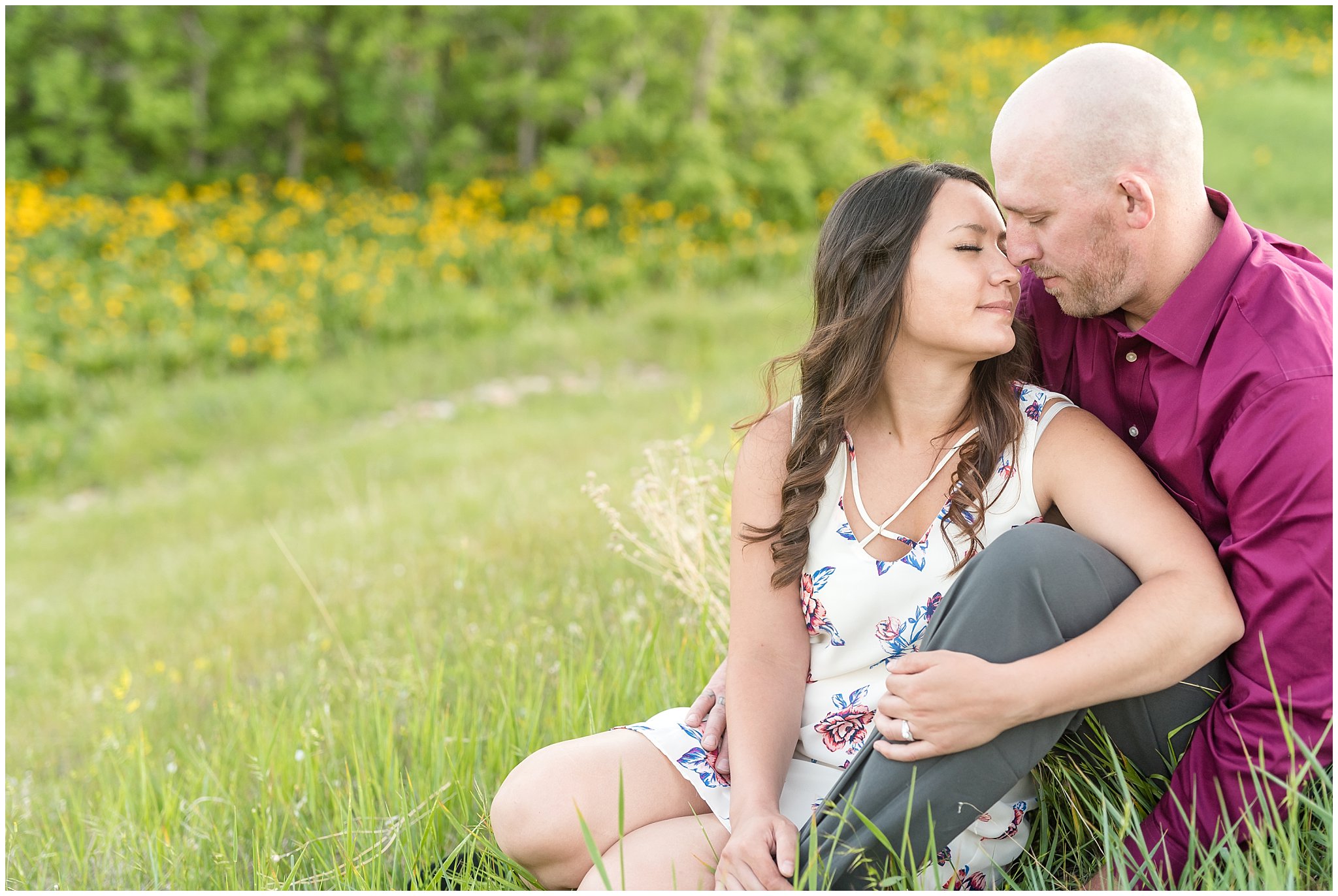 Romantic couple engagement session with mountains in the background and wildflowers | Snowbasin Utah Engagements