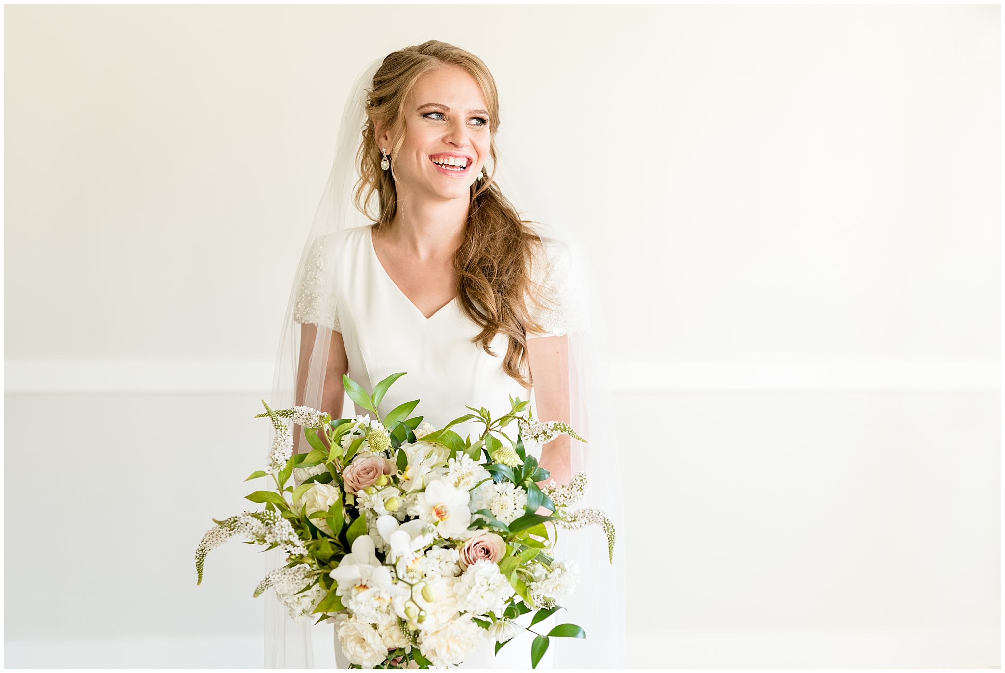 Bright and joyful laughing bridal shot with bouquet | Talia Event Center