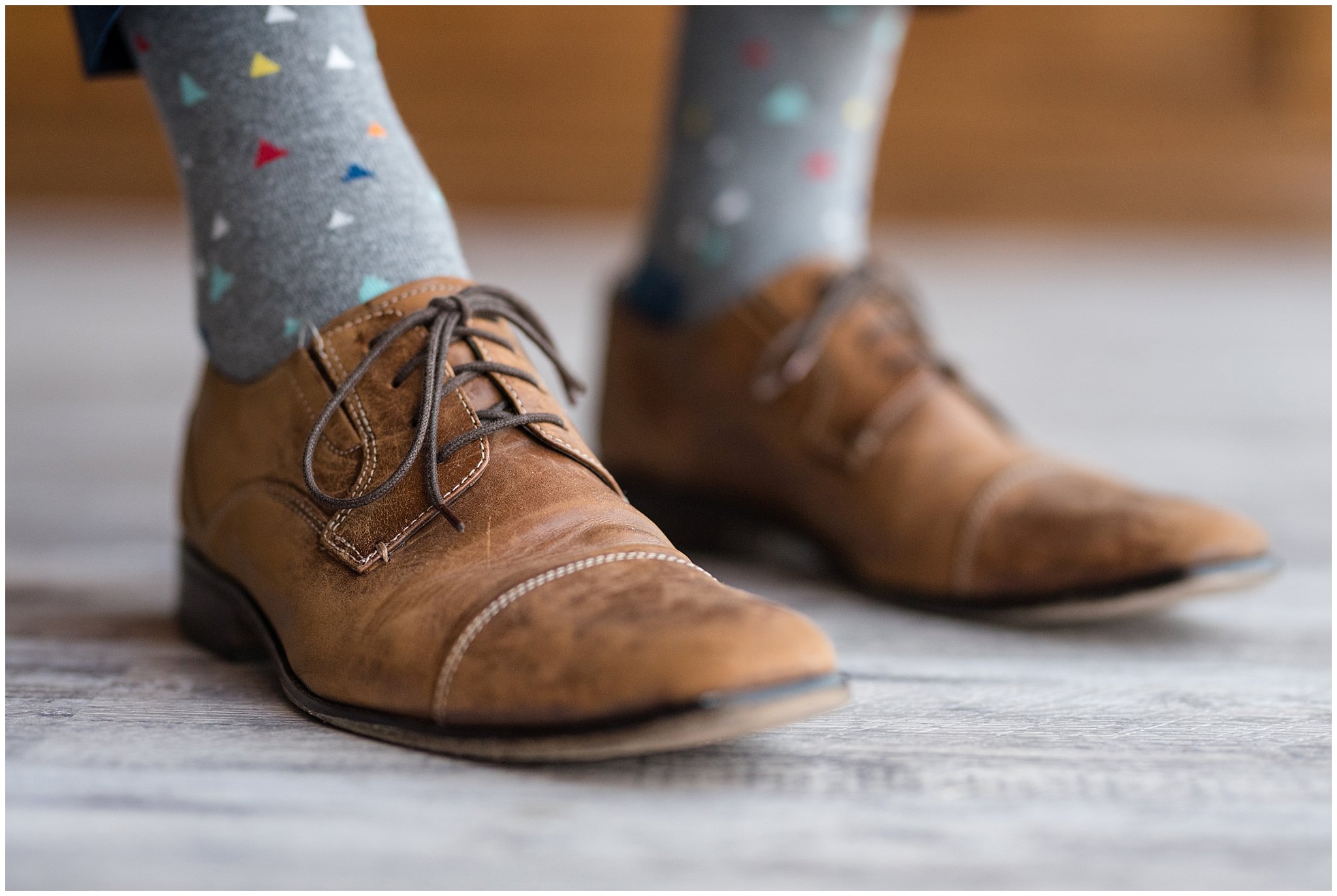 Detail shot of groom's brown leather shoes and fun geometric socks | Talia Event Center