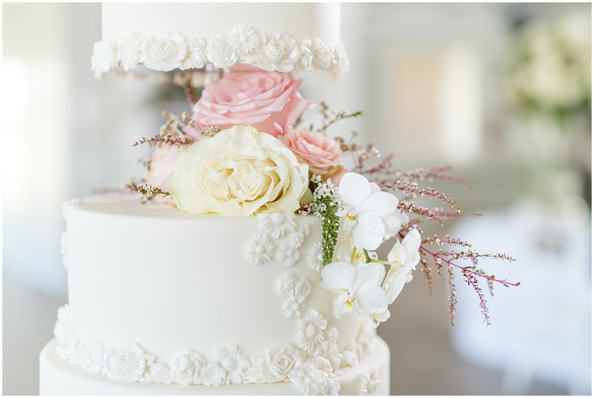 Eight tier white elegant wedding cake | gold, navy and white wedding | Roses accenting the cake | Talia Event Center