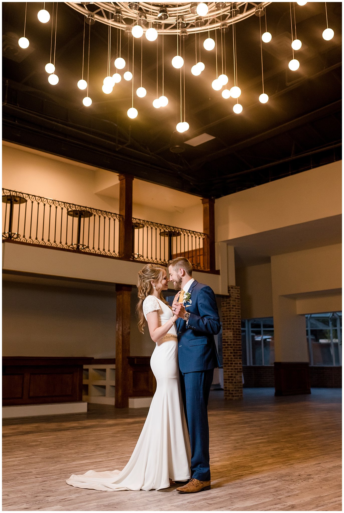Bride and groom dancing at Talia Event center under the lights | Navy, white and gold wedding | Talia Event Center