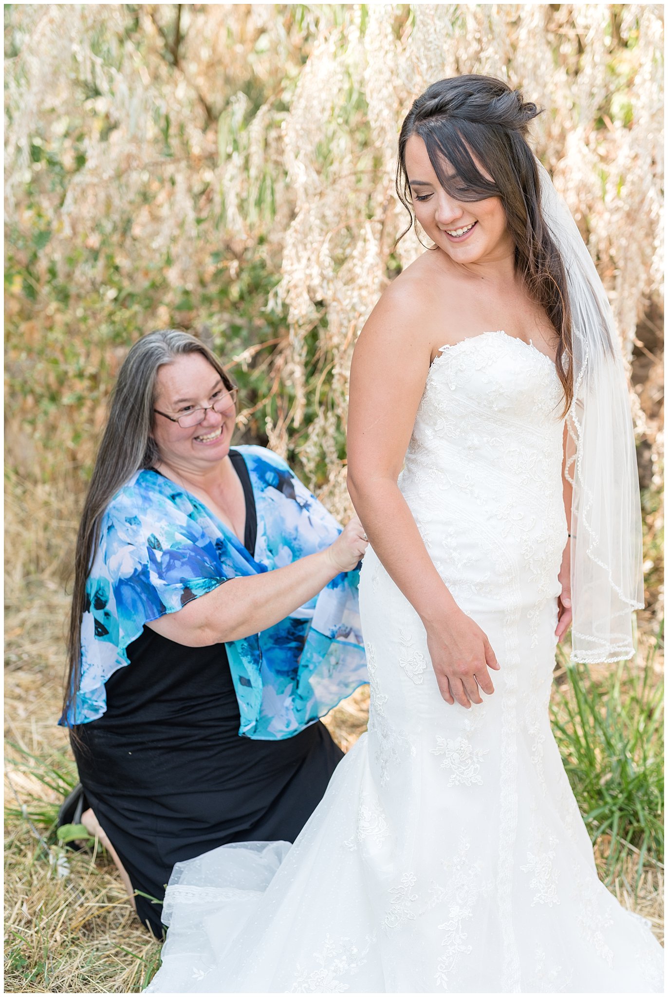 Mother of the Bride smiling and buttoning up back of wedding dress | Davis County Outdoor Wedding | Jessie and Dallin Photography