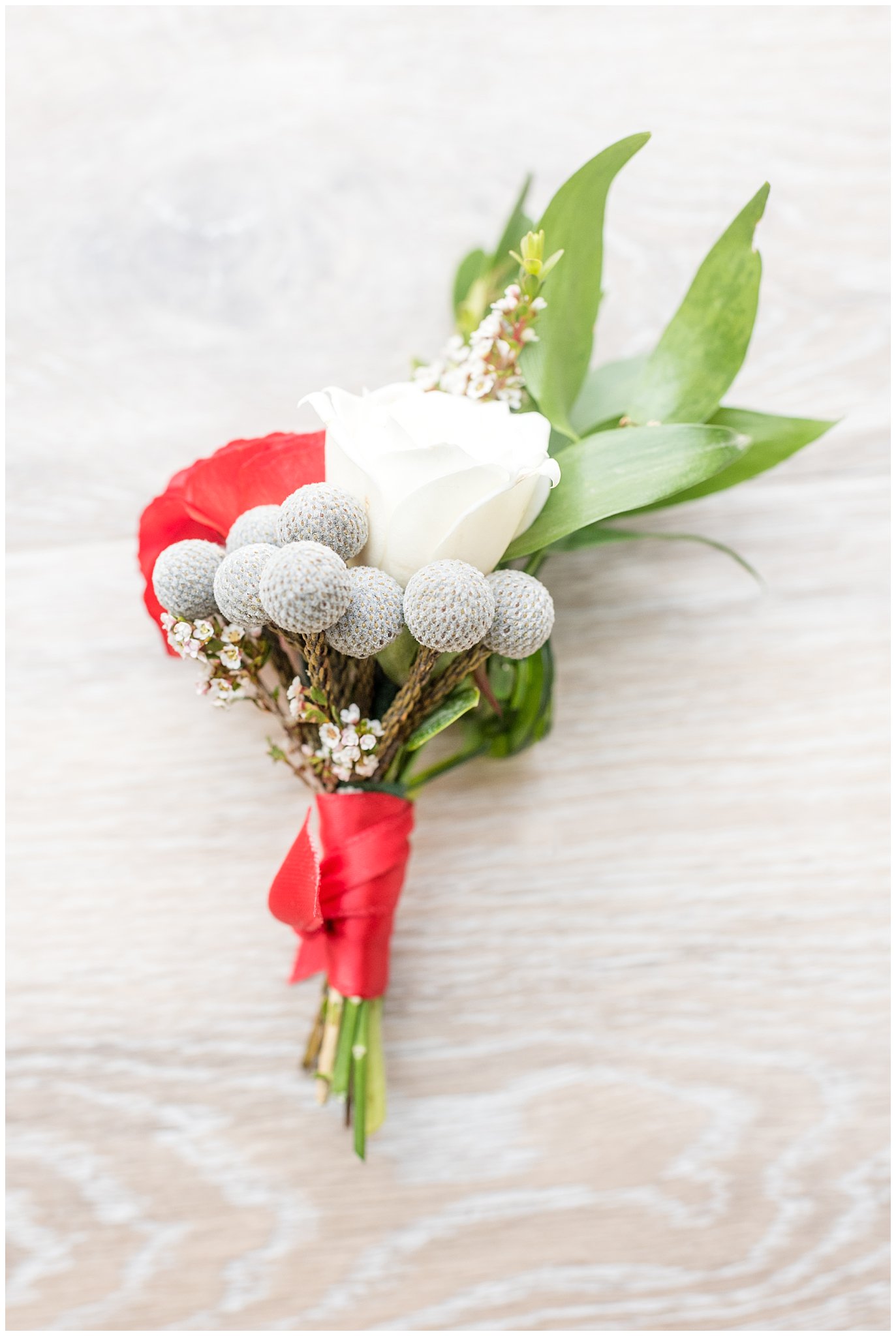 Close up detail of red and grey boutonniere | Davis County Outdoor Wedding | Jessie and Dallin Photography