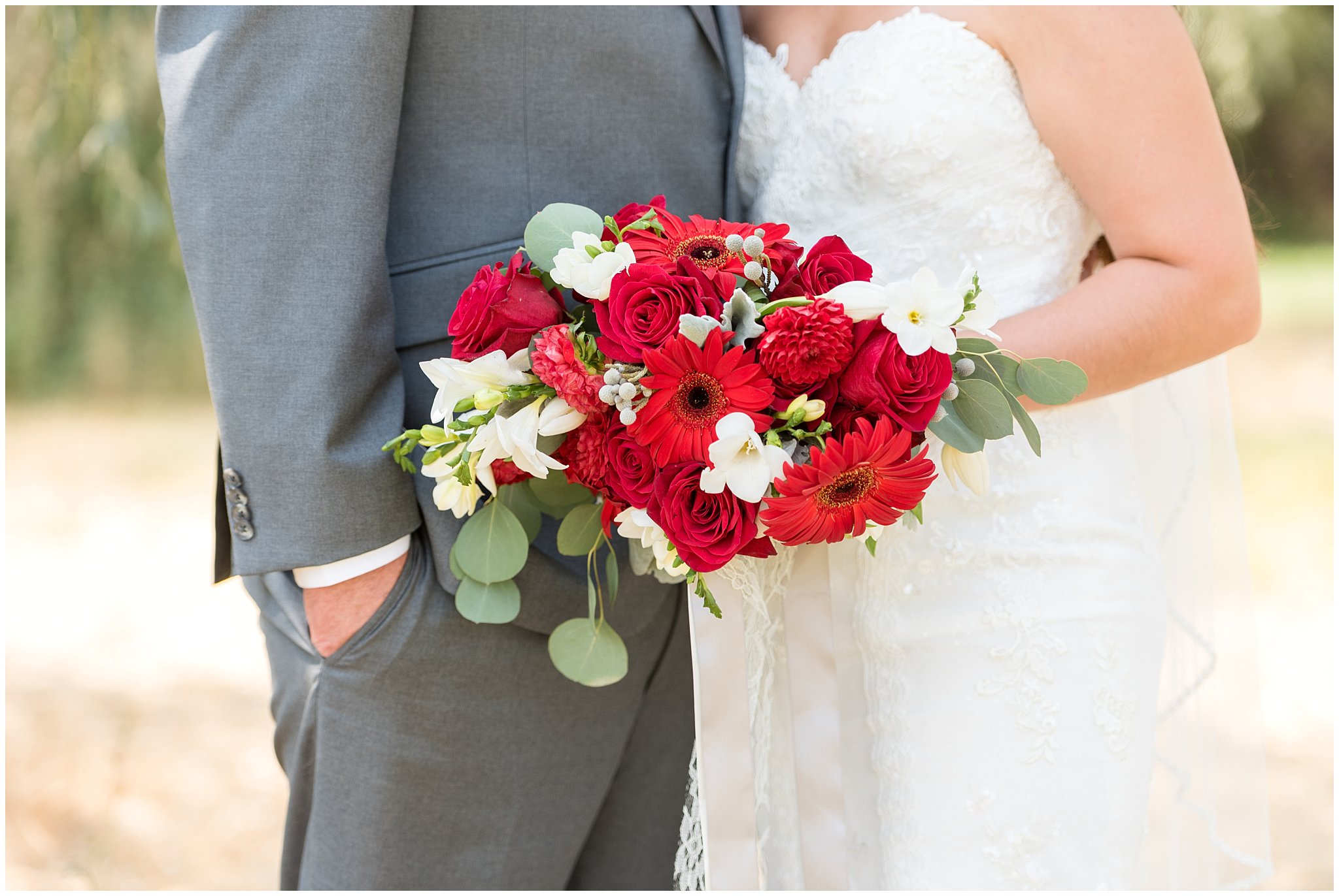 Bride and groom holding red and white bouquet | Davis County Outdoor Wedding | Jessie and Dallin Photography
