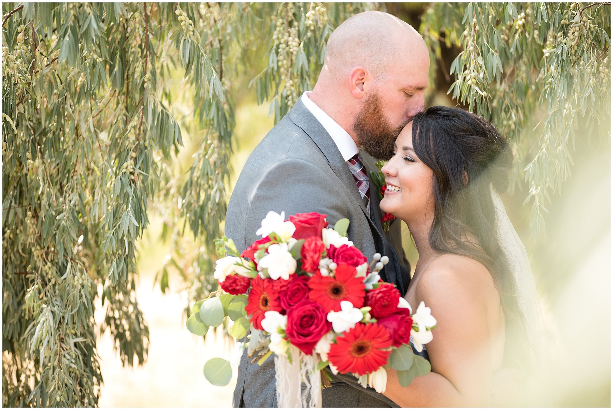 Bride candidly laughing as groom kisses her forehead | Davis County Outdoor Wedding | Jessie and Dallin Photography