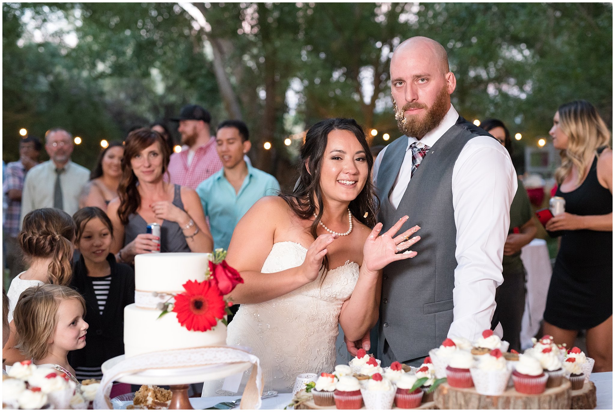 Bride and groom covered in cake during cake cutting | Red and Grey wedding | Davis County Outdoor Wedding | Jessie and Dallin Photography