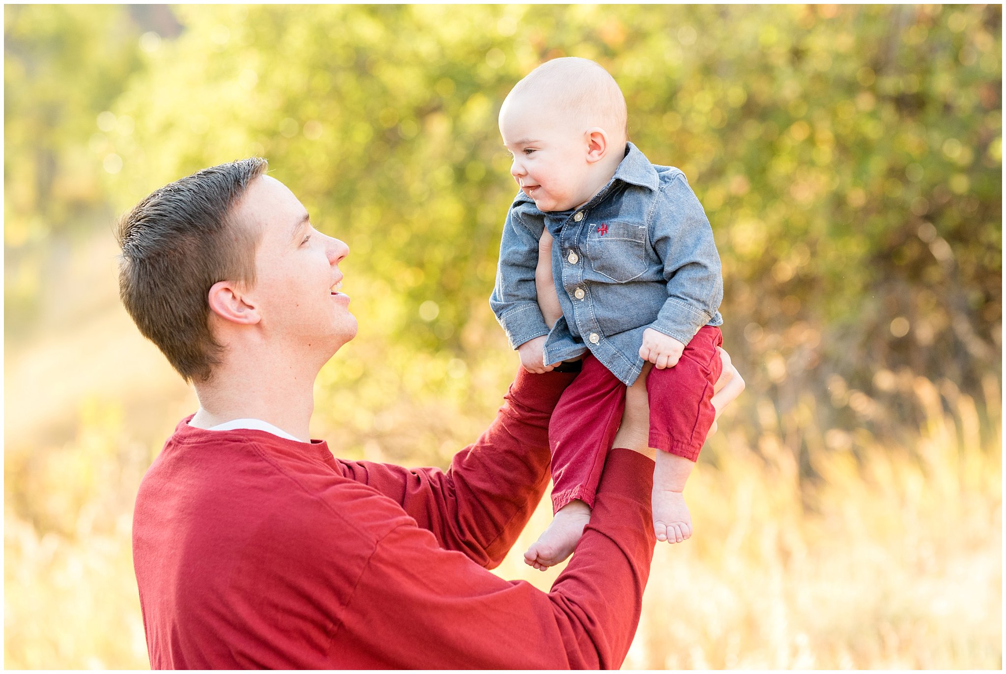 Dad holds baby boy up in the air smiling | Fall Family Pictures at Snowbasin | Jessie and Dallin Photography