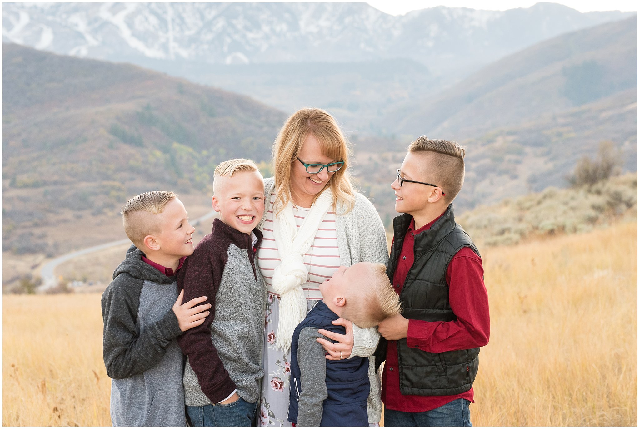 Mom and sons laughing and having fun in front of snowy mountains | Fall Family Pictures in the Mountains | Snowbasin, Utah | Jessie and Dallin Photography