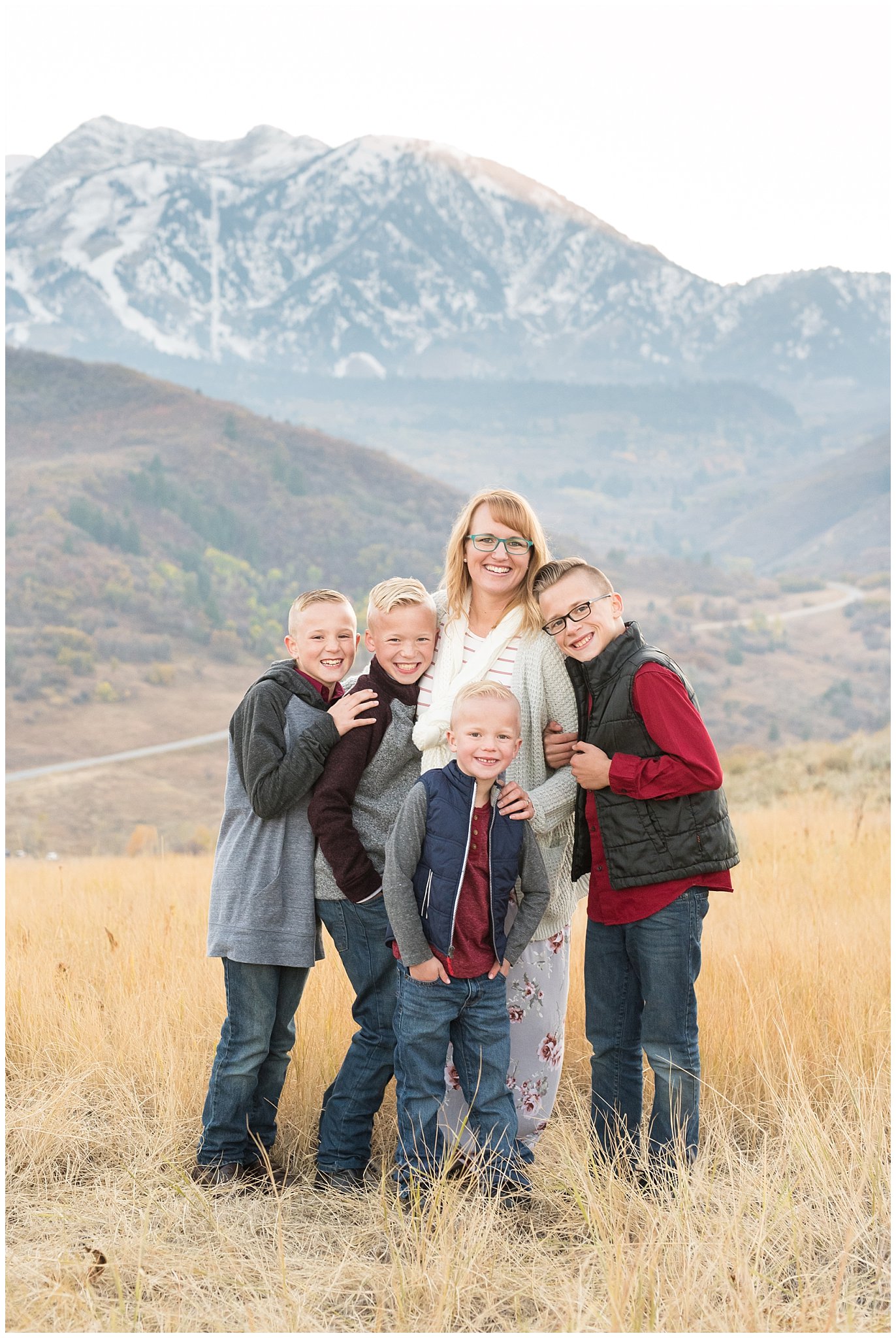 Mom and sons smiling in front of snowy mountains | Fall Family Pictures in the Mountains | Snowbasin, Utah | Jessie and Dallin Photography