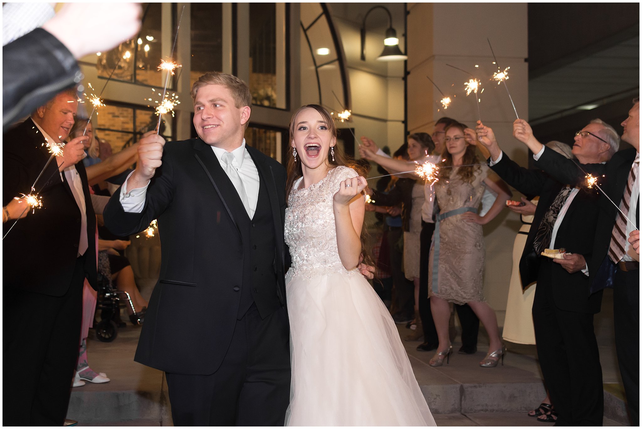 Bride and Groom celebrate during sparkler exit | The Grand View Venue | Utah Wedding Photographers | Jessie and Dallin