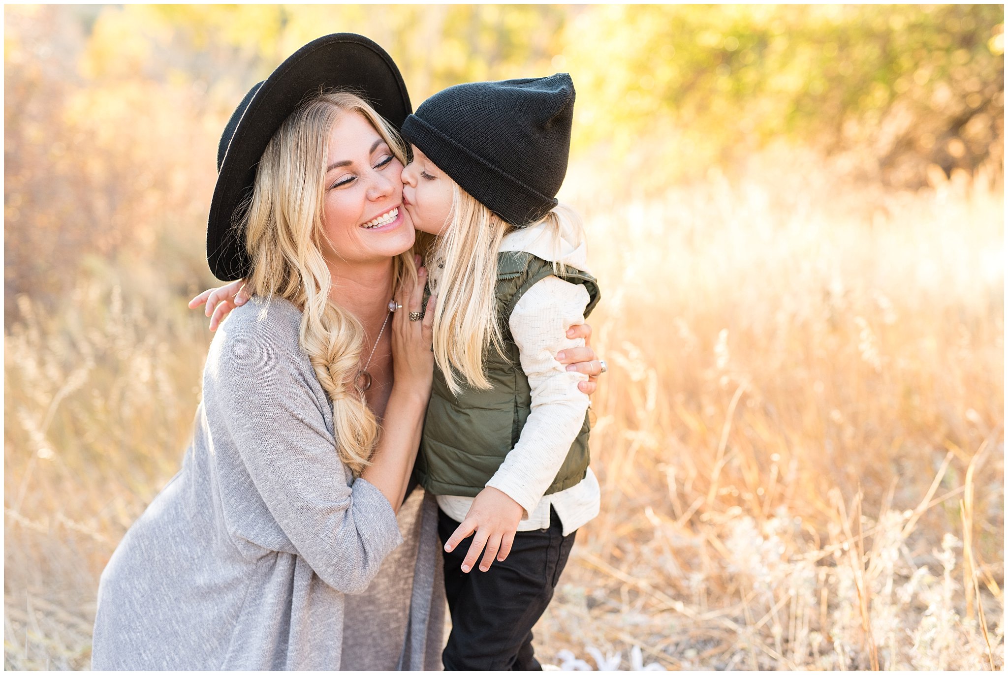 Mom wearing black wide brim hat and getting a kiss from son | Fall Family Pictures in the Mountains | Snowbasin, Utah | Jessie and Dallin
