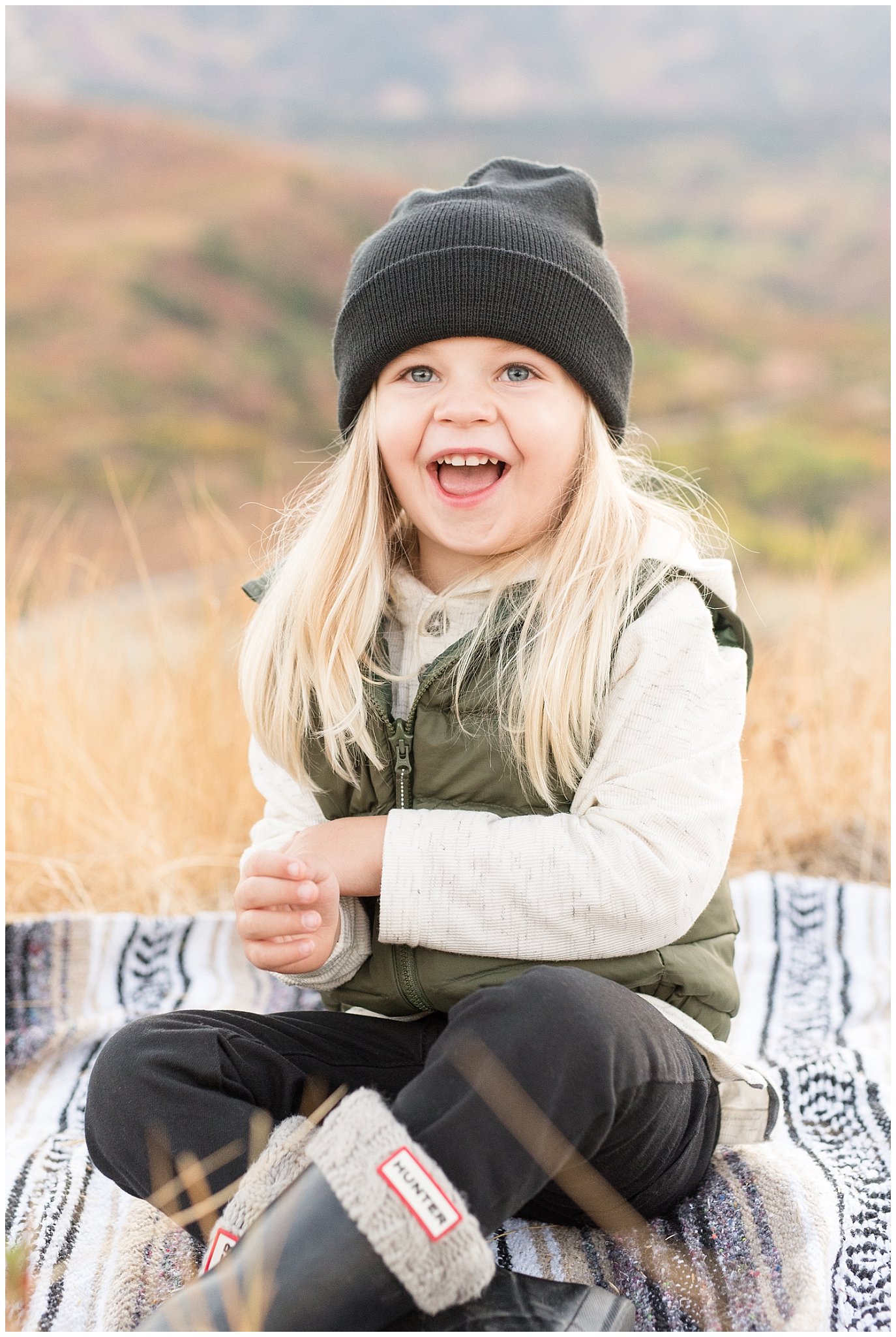 3 year old laughing during fall family pictures | Fall Family Pictures in the Mountains | Snowbasin, Utah | Jessie and Dallin