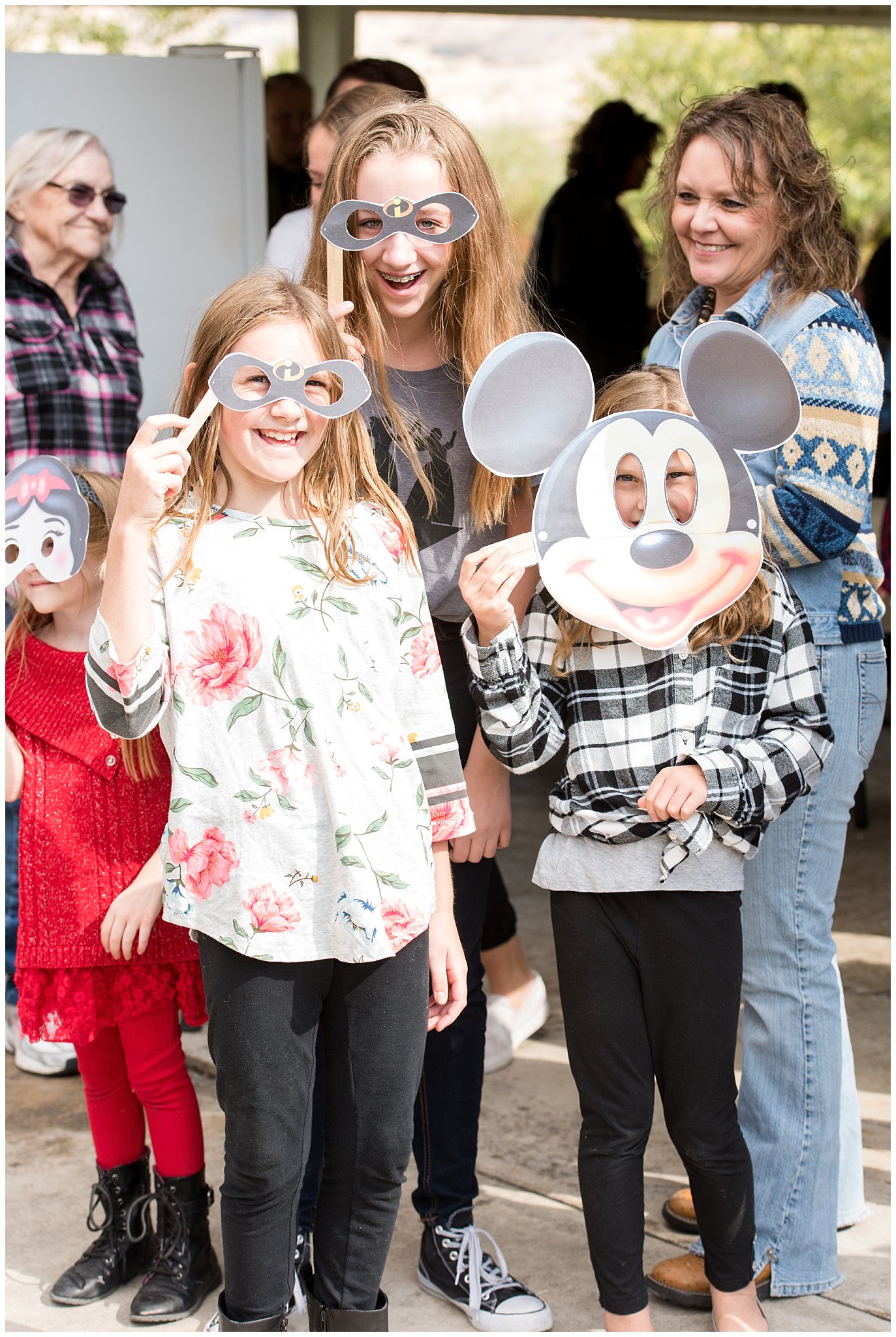 Wearing Disney character masks for big group picture | Tremonton Family Pictures and Make a Wish Event | Jessie and Dallin Photography