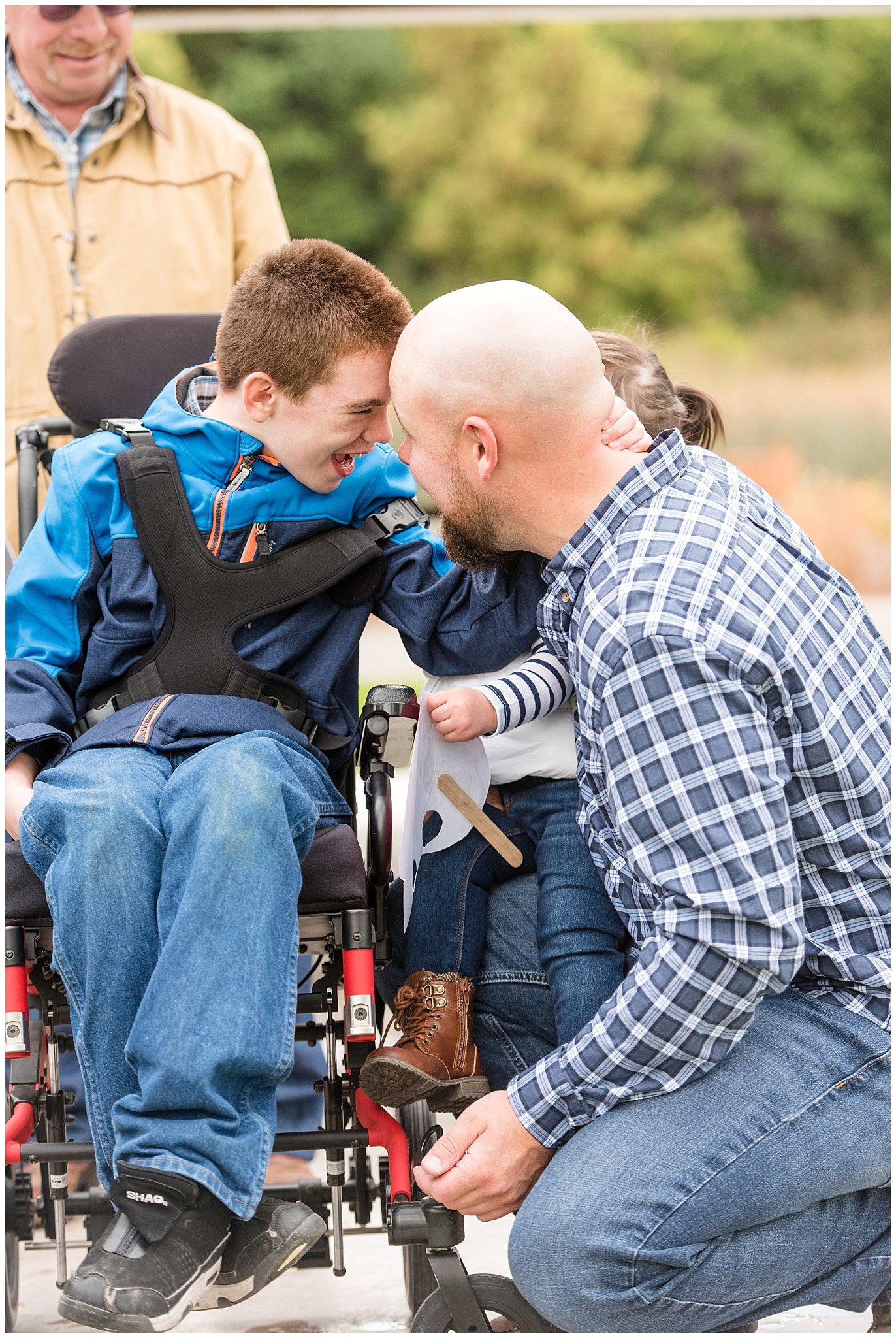 Boy in wheel chair and brother touching heads | Tremonton Family Pictures and Make a Wish Event | Jessie and Dallin Photography