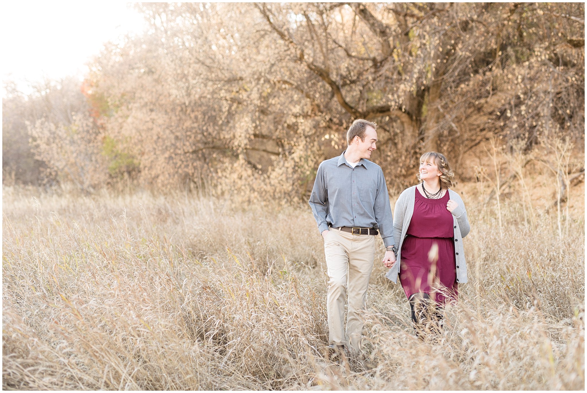 Couple walking in a field and laughing | Davis County Fall Engagement | Utah Wedding Photographers | Jessie and Dallin