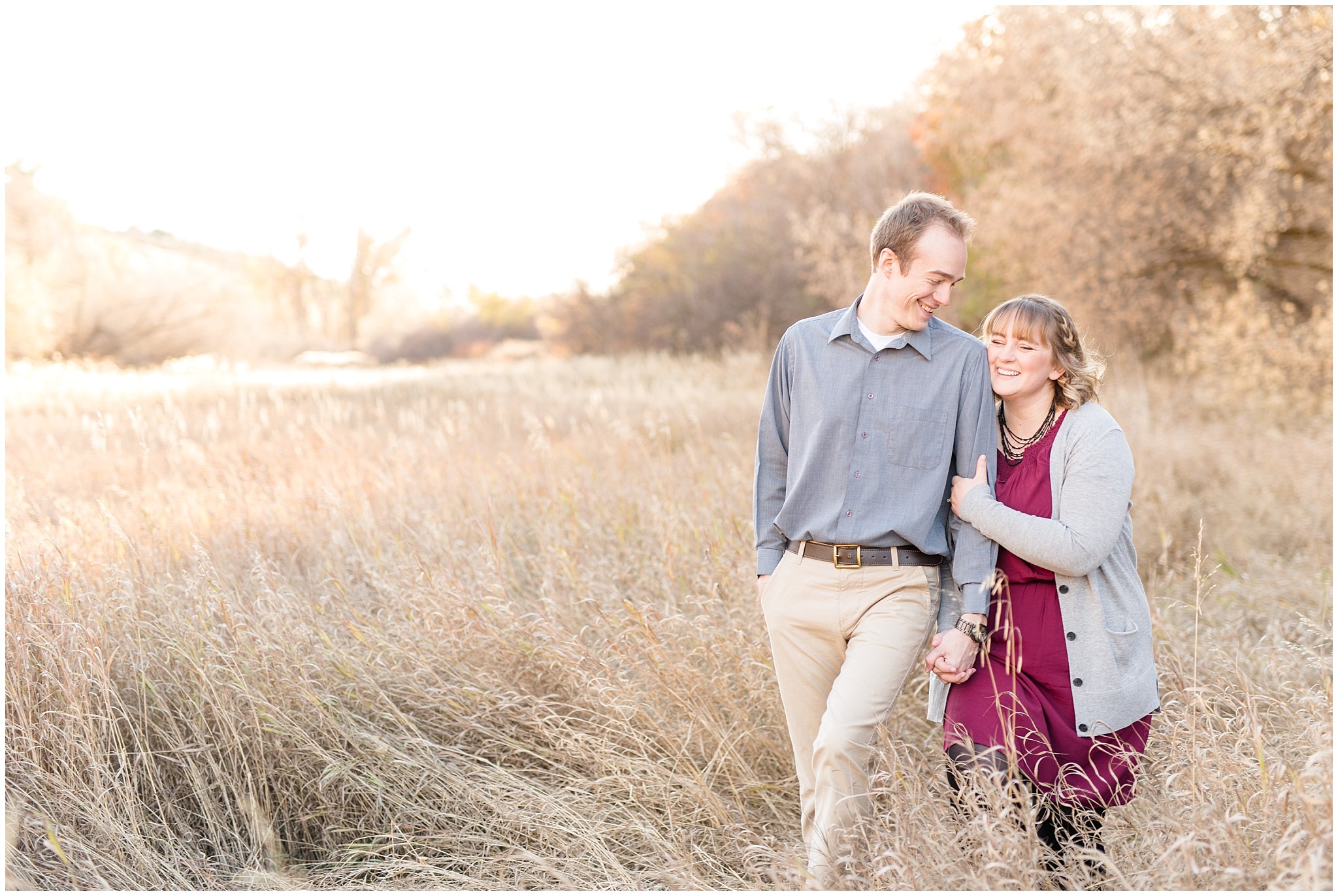 Couple walking and holding tight in a field | Davis County Fall Engagement | Utah Wedding Photographers | Jessie and Dallin