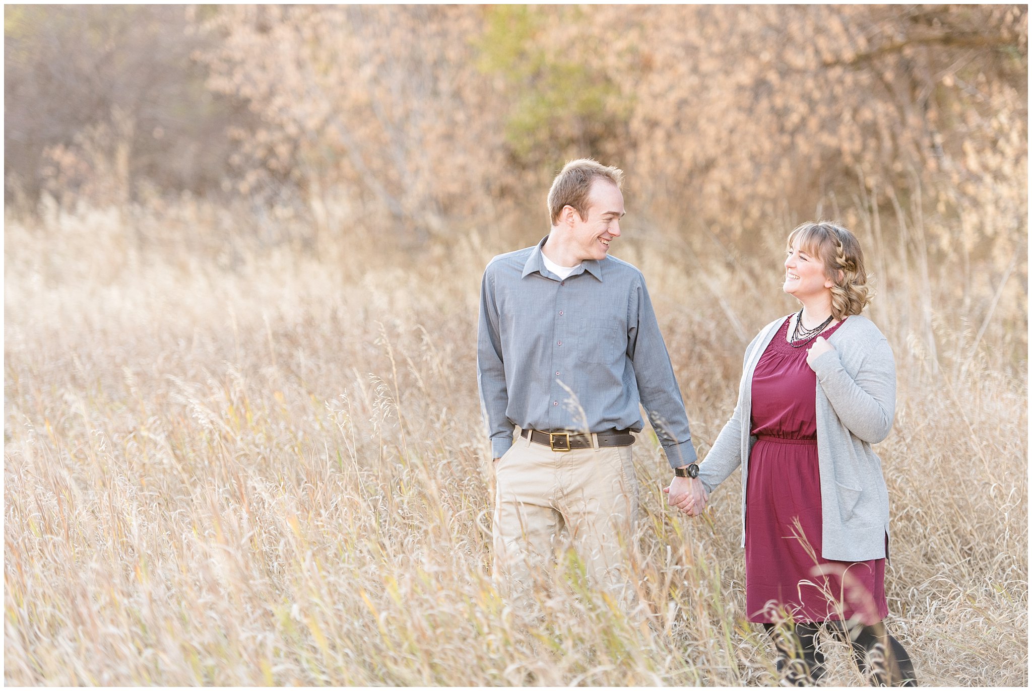Couple walking and laughing in a field | Davis County Fall Engagement | Utah Wedding Photographers | Jessie and Dallin