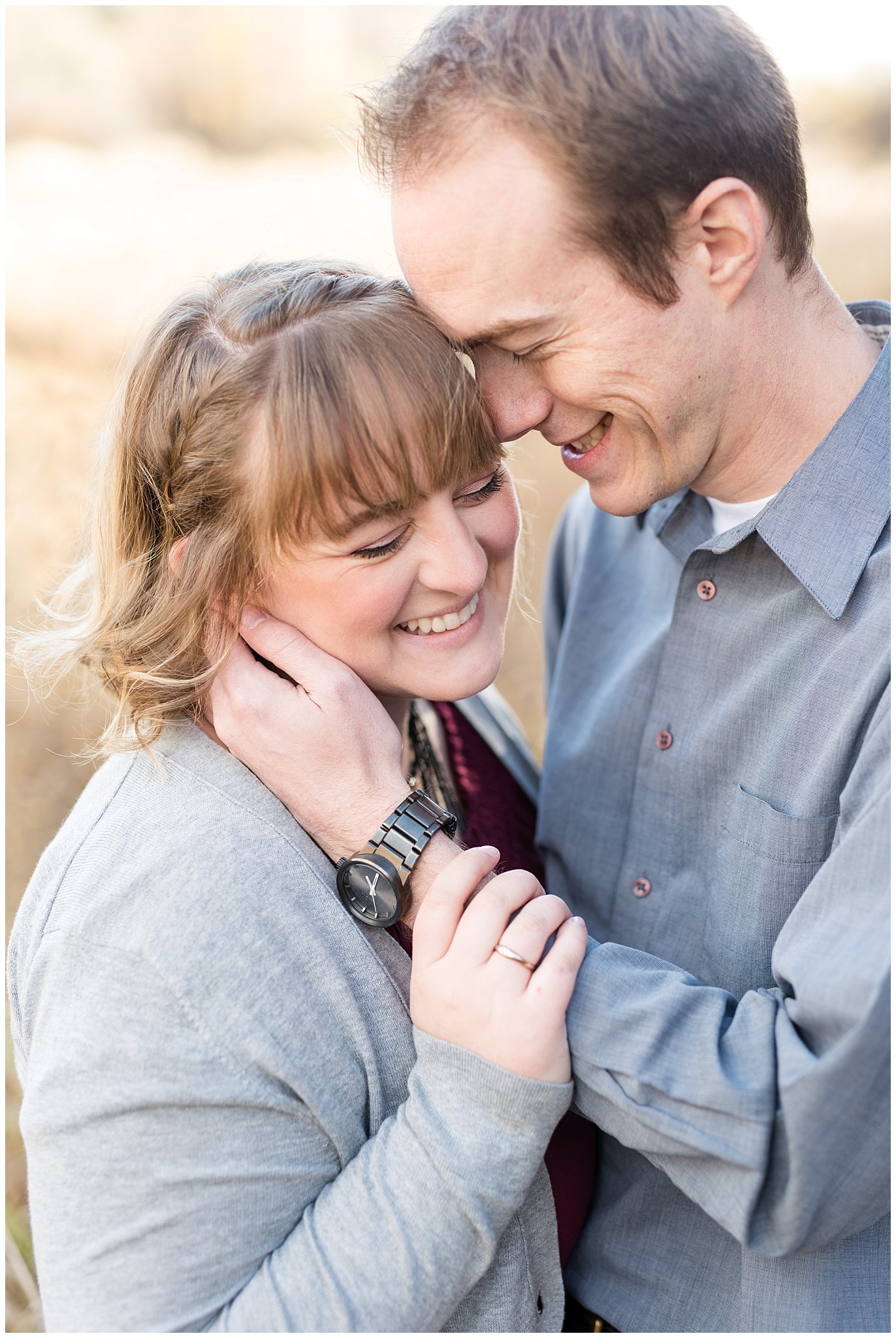 Couple smiling and laughing in a field | Davis County Fall Engagement | Utah Wedding Photographers | Jessie and Dallin