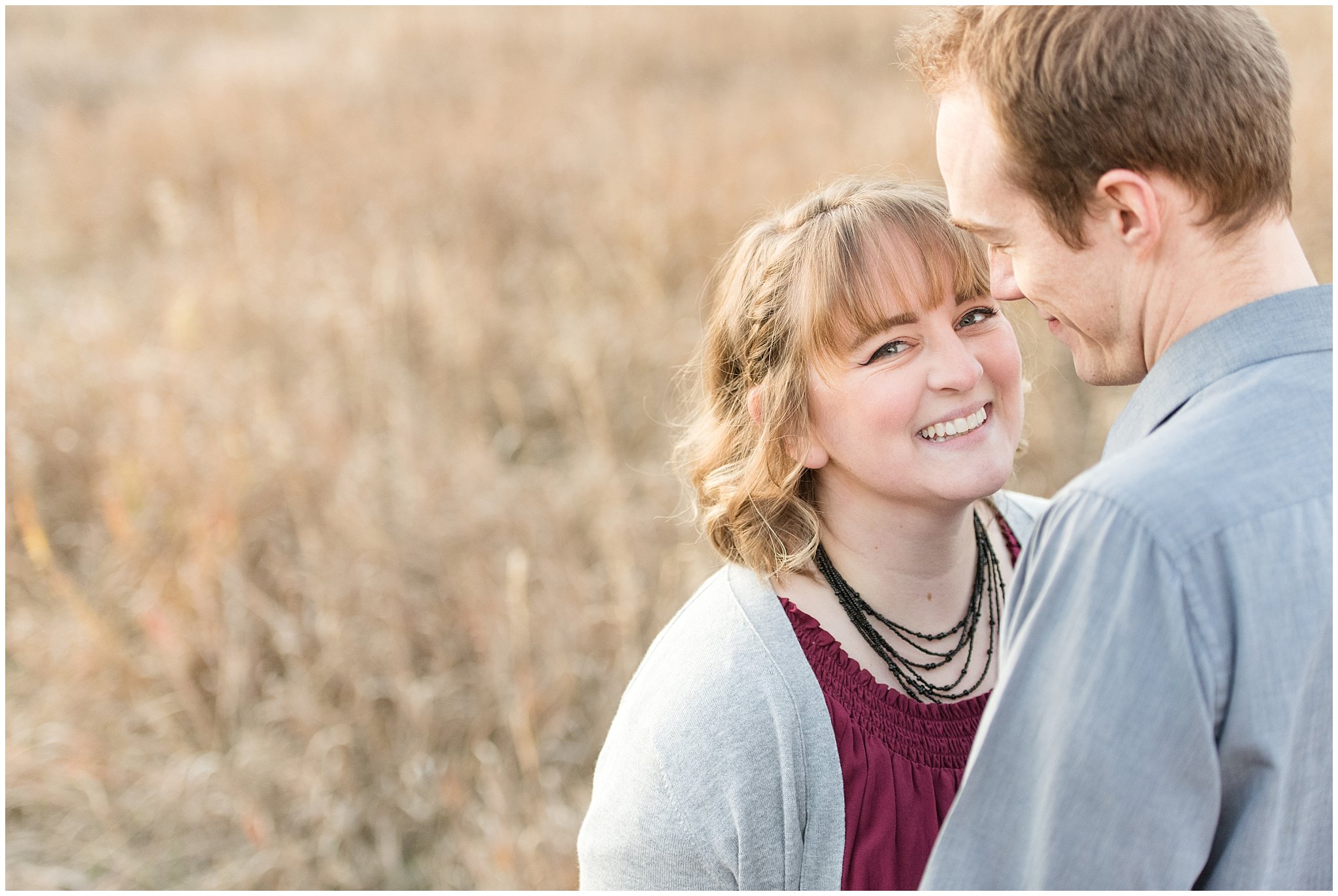 Girl smiling at the camera during field engagements | Davis County Fall Engagement | Utah Wedding Photographers | Jessie and Dallin