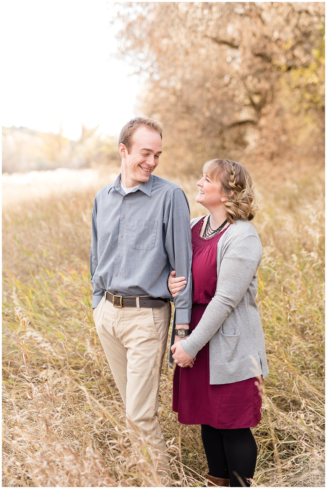 Couple laughing in a field | Davis County Fall Engagement | Utah Wedding Photographers | Jessie and Dallin