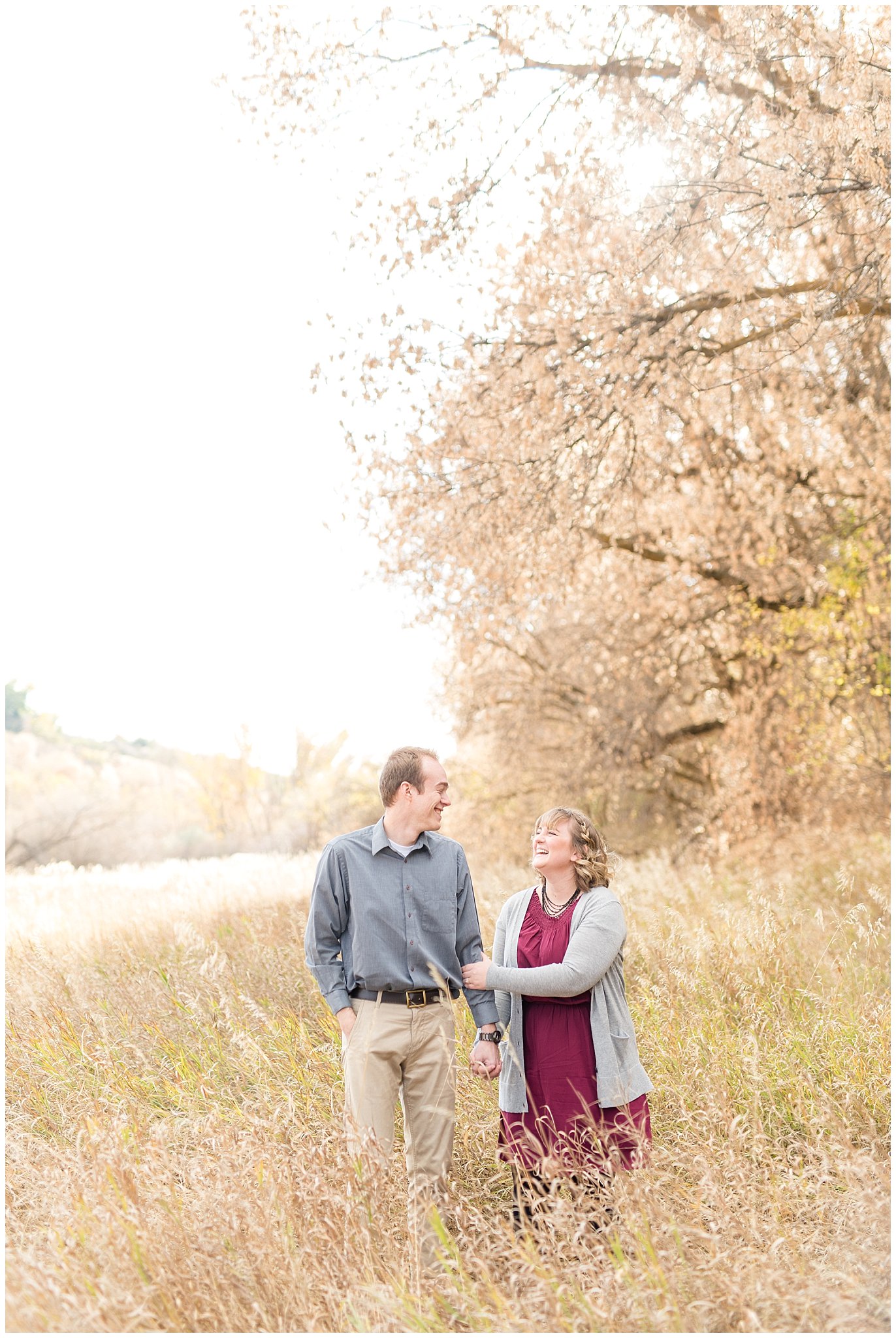 Couple walking and laughing during field engagement | Davis County Fall Engagement | Utah Wedding Photographers | Jessie and Dallin