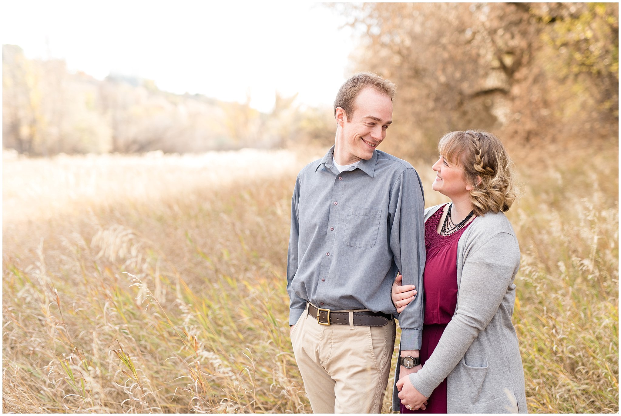 Couple laughing in a field | Davis County Fall Engagement | Utah Wedding Photographers | Jessie and Dallin