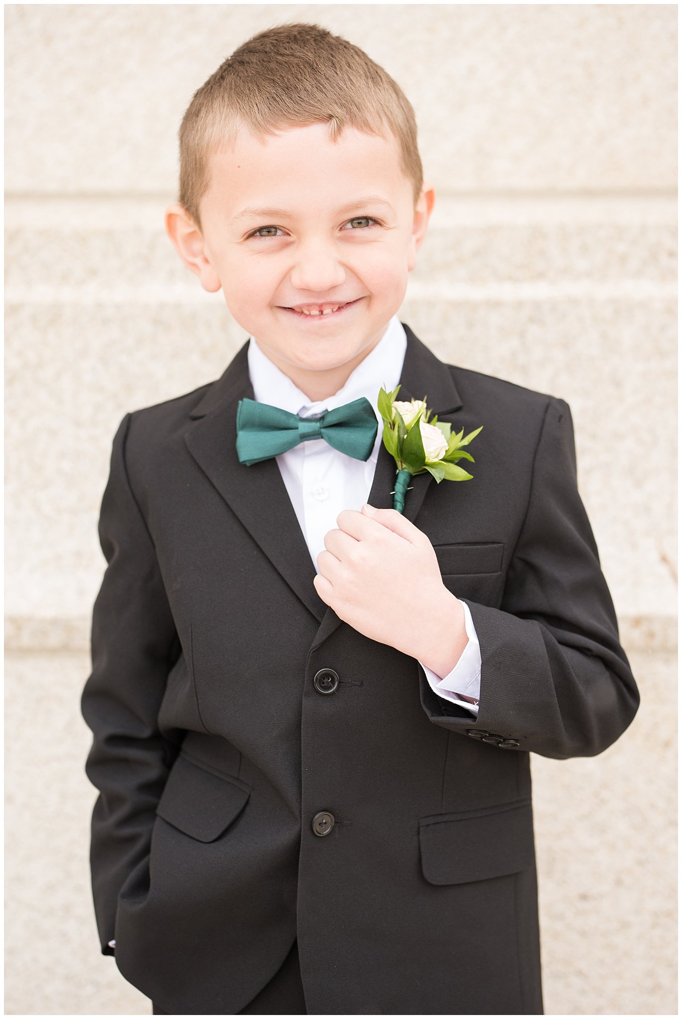 Ringer bearer kid with green bowtie | Ogden Temple Winter Wedding | Emerald Green and Pink Wedding | Jessie and Dallin Photography