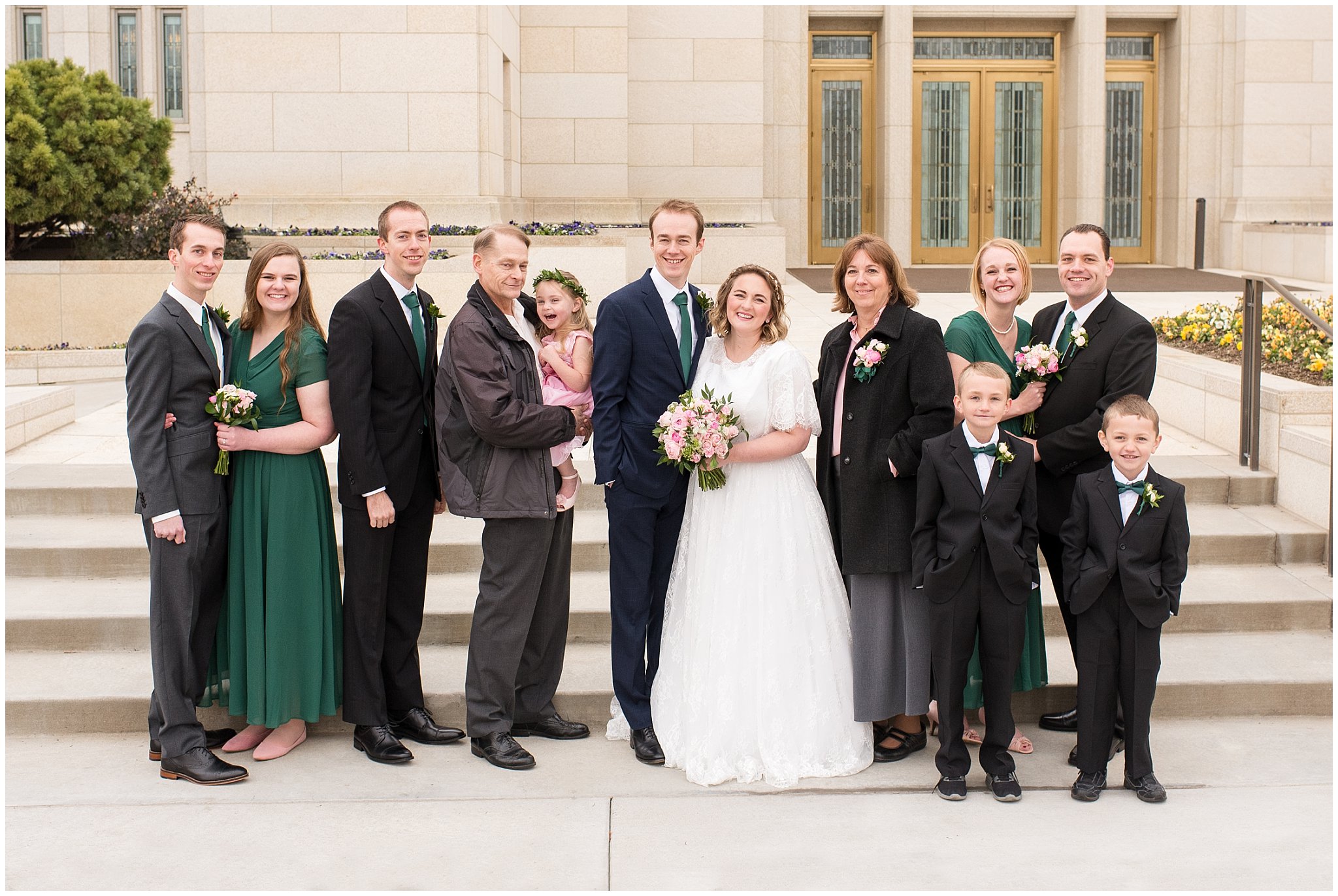 Groom's family smiling in front of the temple | Ogden Temple Winter Wedding | Emerald Green and Pink Wedding | Jessie and Dallin Photography