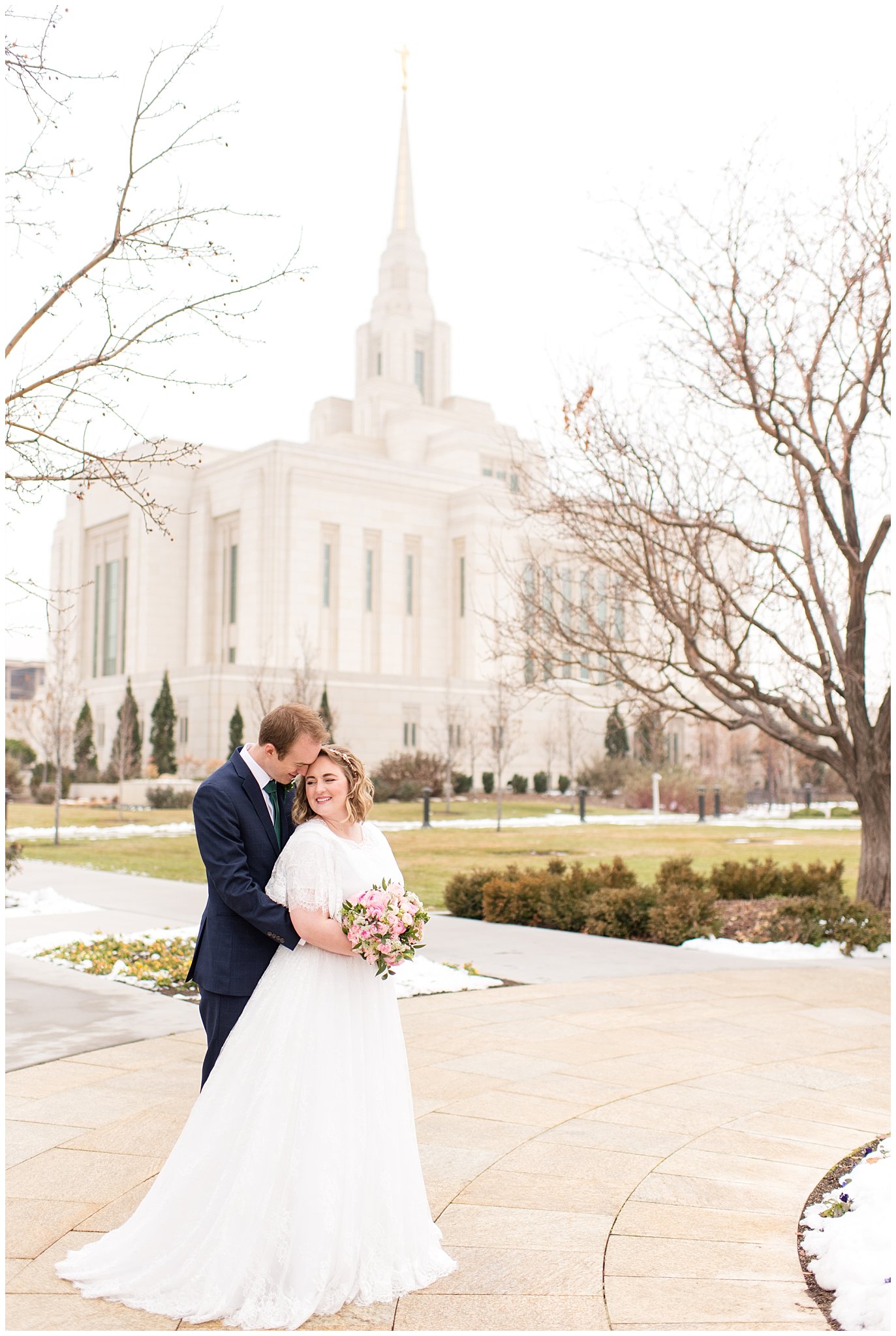 Bride and groom in front of Ogden temple | Ogden Temple Winter Wedding | Emerald Green and Pink Wedding | Jessie and Dallin Photography