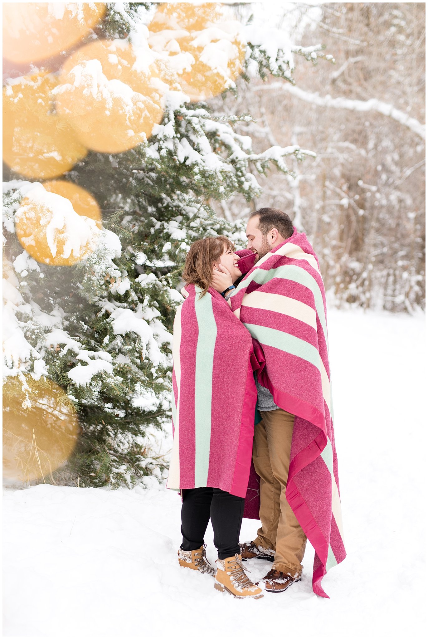 Couple wrapped in warm blanket in the snowy forest | Winter Engagement at Mueller Park and the Utah State Capitol | Jessie and Dallin Photography