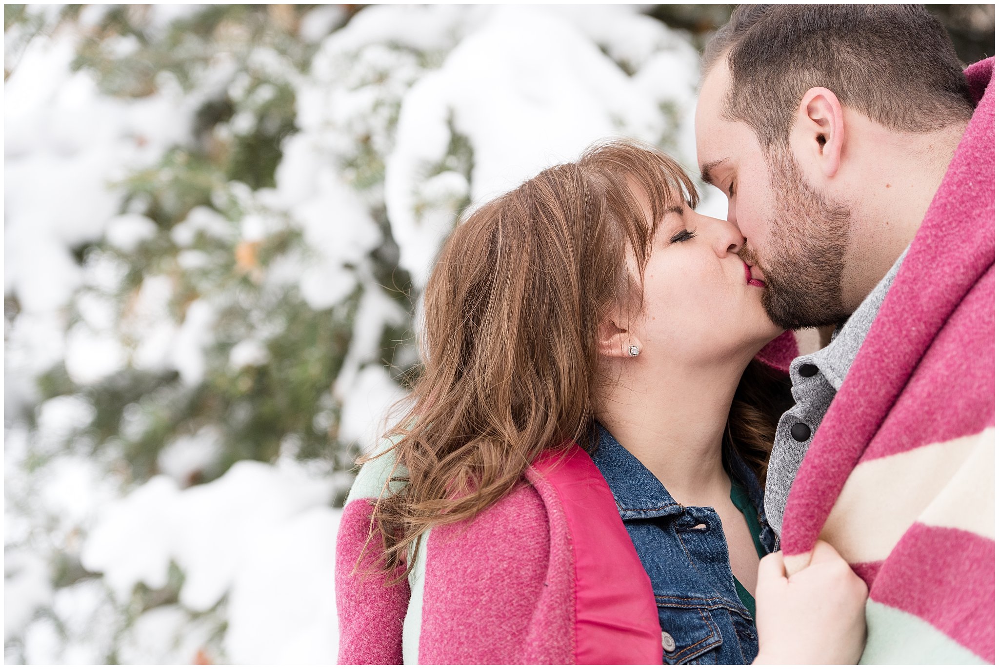 Couple kisses while wrapped in blanket in the snow | Winter Engagement at Mueller Park and the Utah State Capitol | Jessie and Dallin Photography