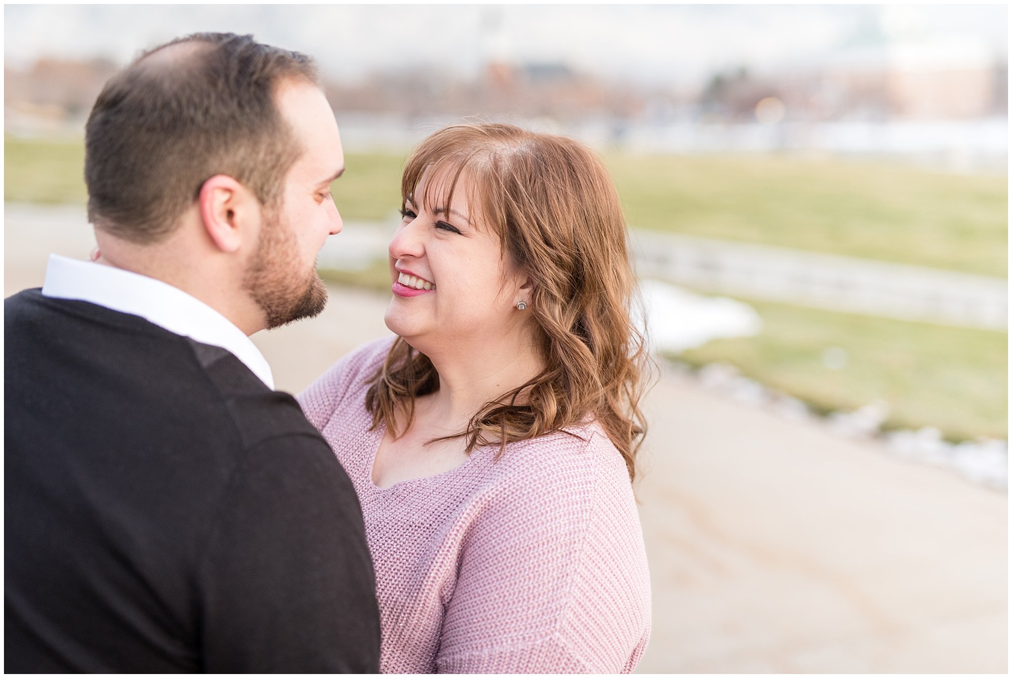 Couple smiling at each other on a path | Winter Engagement at Mueller Park and the Utah State Capitol | Jessie and Dallin Photography