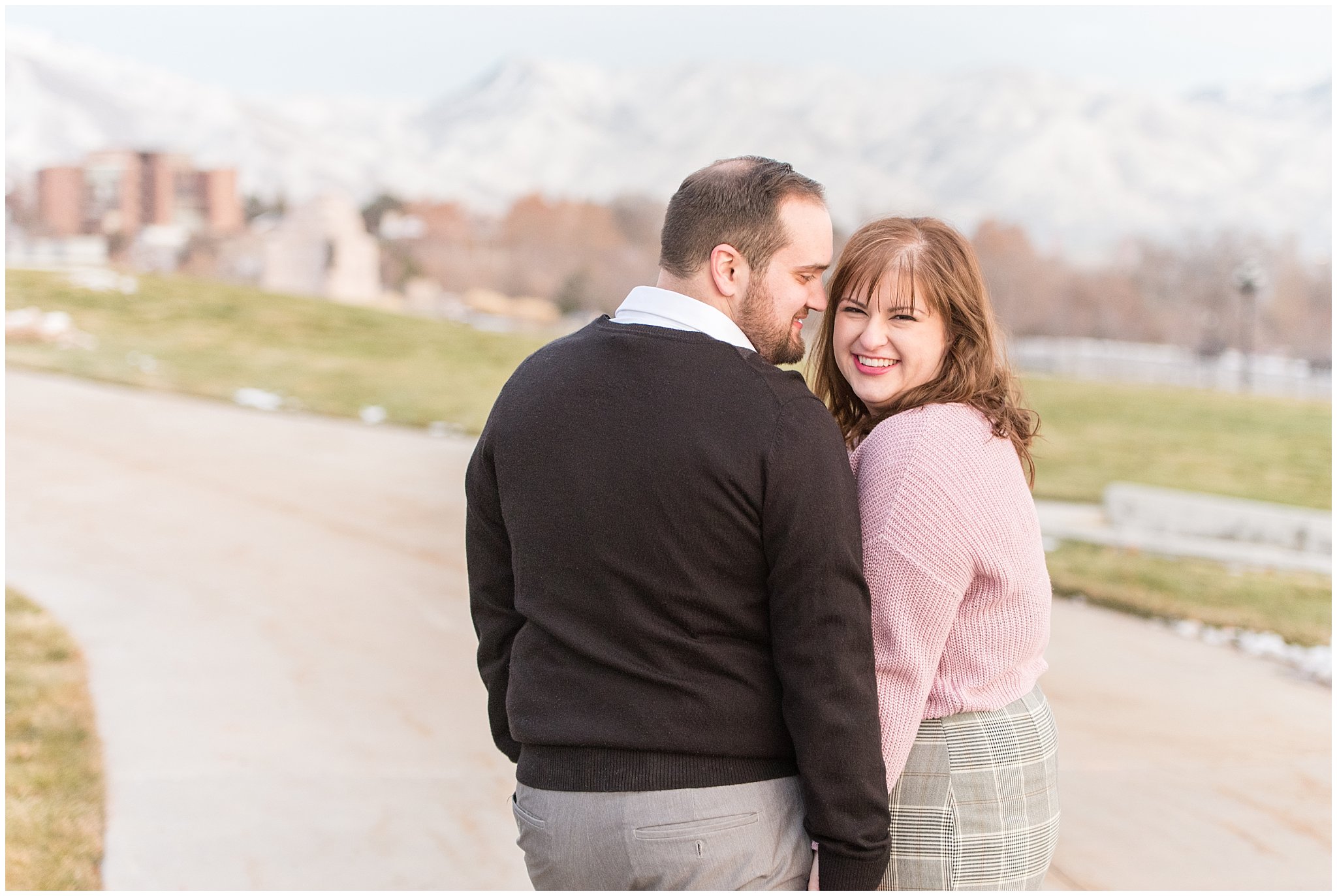 Girl smiling at the camera while walking on a path | Winter Engagement at Mueller Park and the Utah State Capitol | Jessie and Dallin Photography
