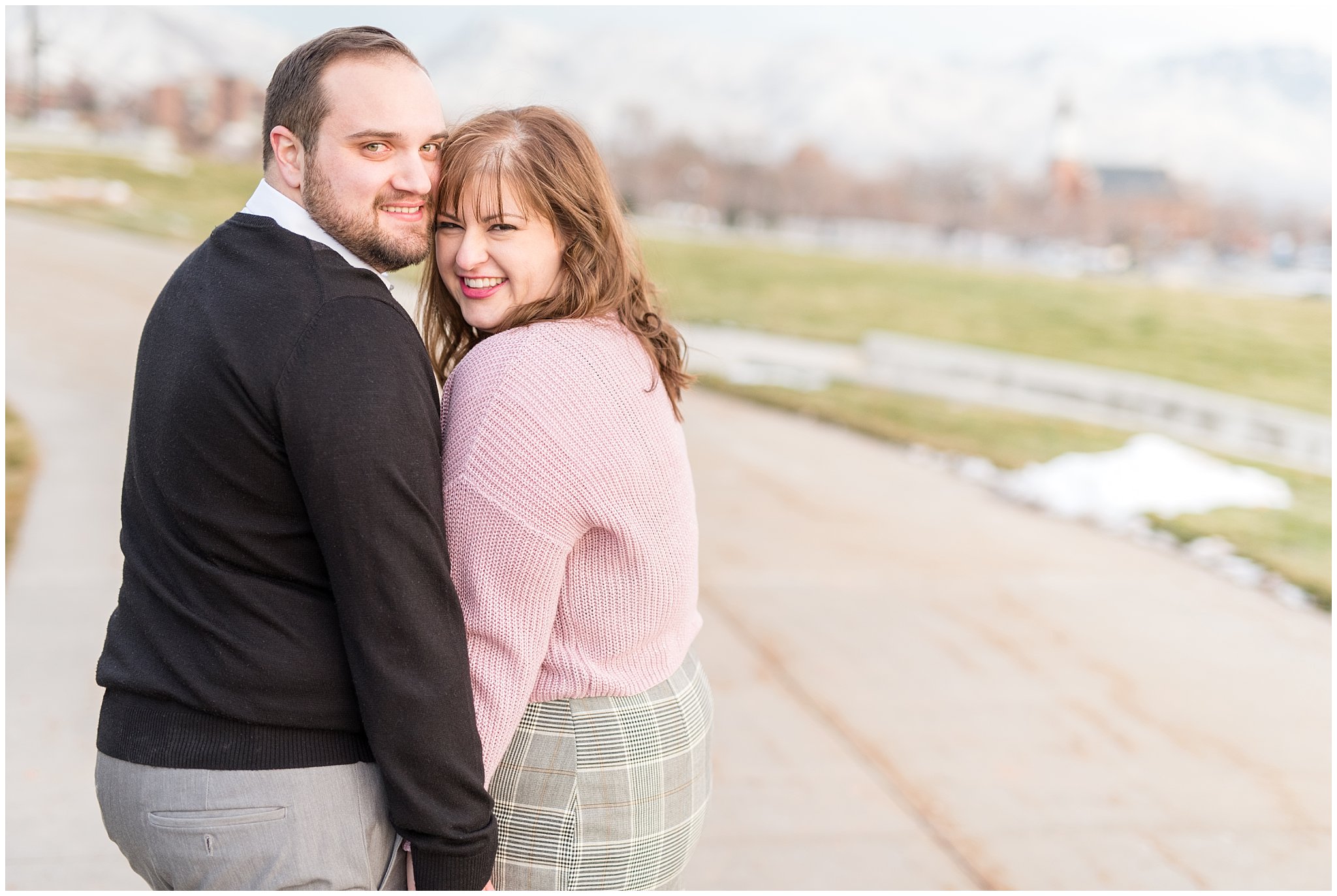Couple walking and smiling on a path at the Utah State Capitol | Winter Engagement at Mueller Park and the Utah State Capitol | Jessie and Dallin Photography