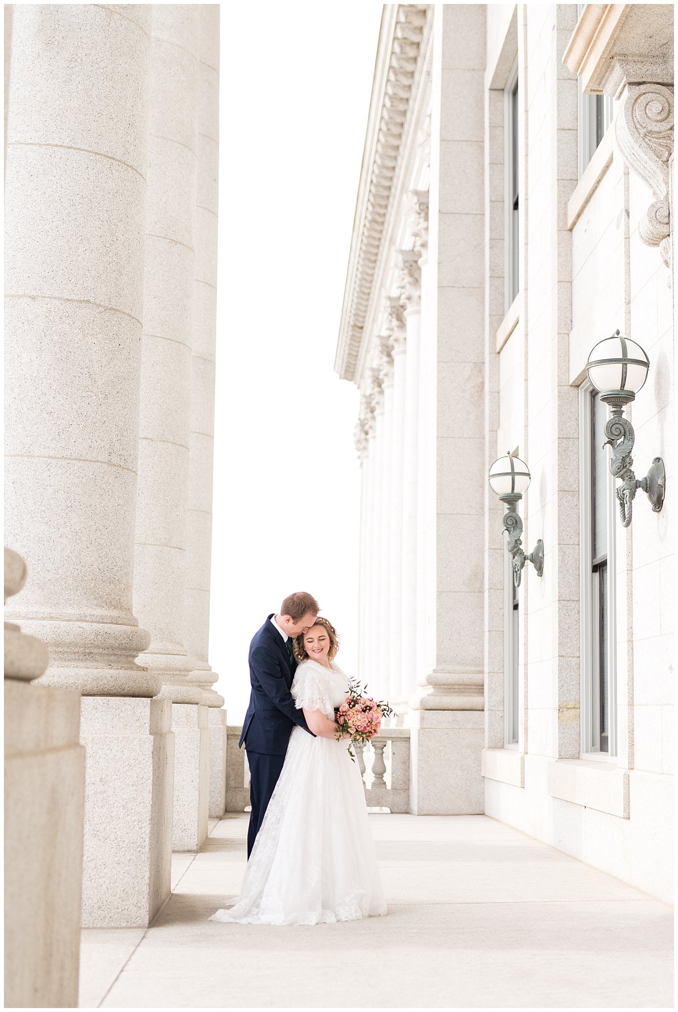 Bride and groom in front of capitol building columns | Winter Formals at the Utah State Capitol | Utah Wedding Photography