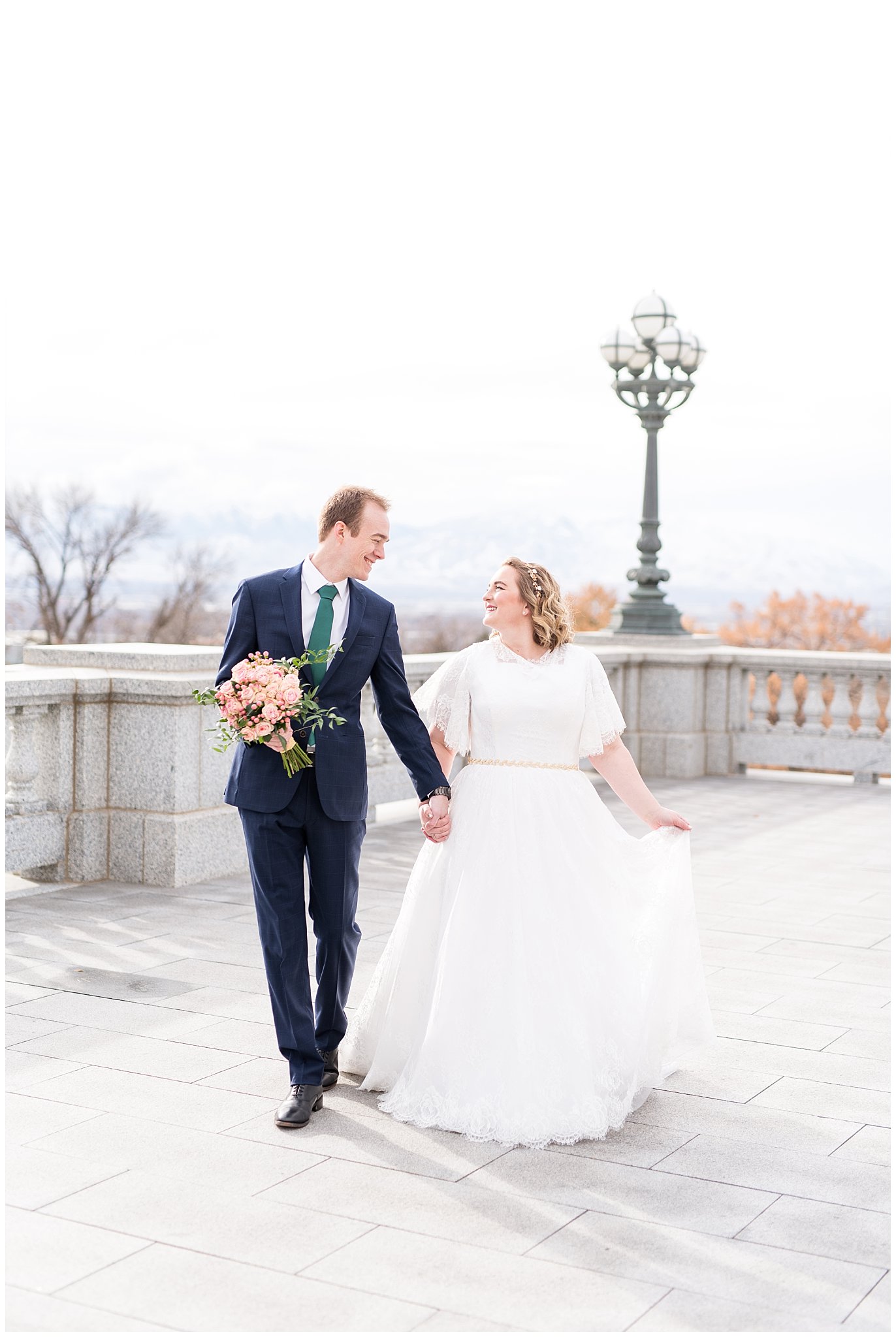 Bride and groom walking with groom holding bouquet | Winter Formals at the Utah State Capitol | Utah Wedding Photography