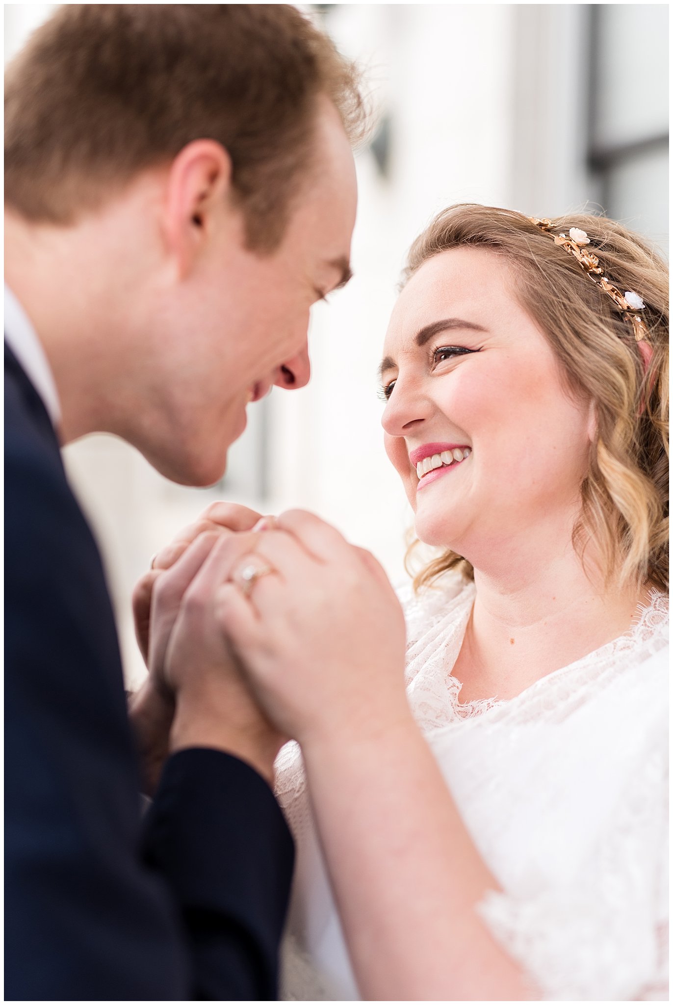 Bride smiles at groom after he kisses her hand | Winter Formals at the Utah State Capitol | Utah Wedding Photography