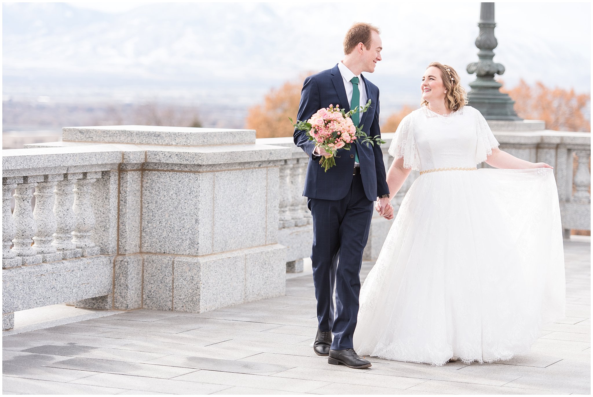 Bride and groom walking while groom holds bouquet | Winter Formals at the Utah State Capitol | Utah Wedding Photography