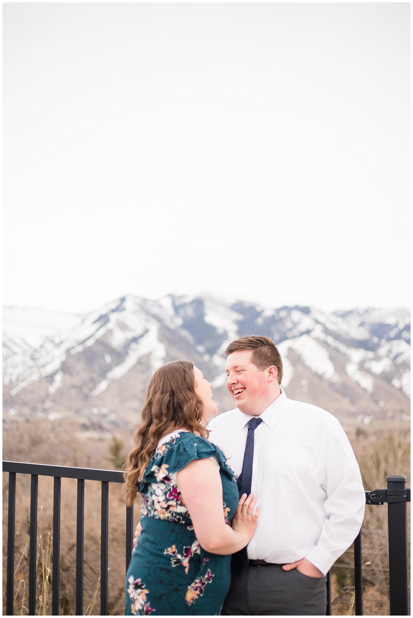 Couple dressed up in white shirt and tie and green blue floral dress by the mountains | Downtown Logan and Green Canyon Engagements | Utah Wedding Photographers | Jessie and Dallin Photography