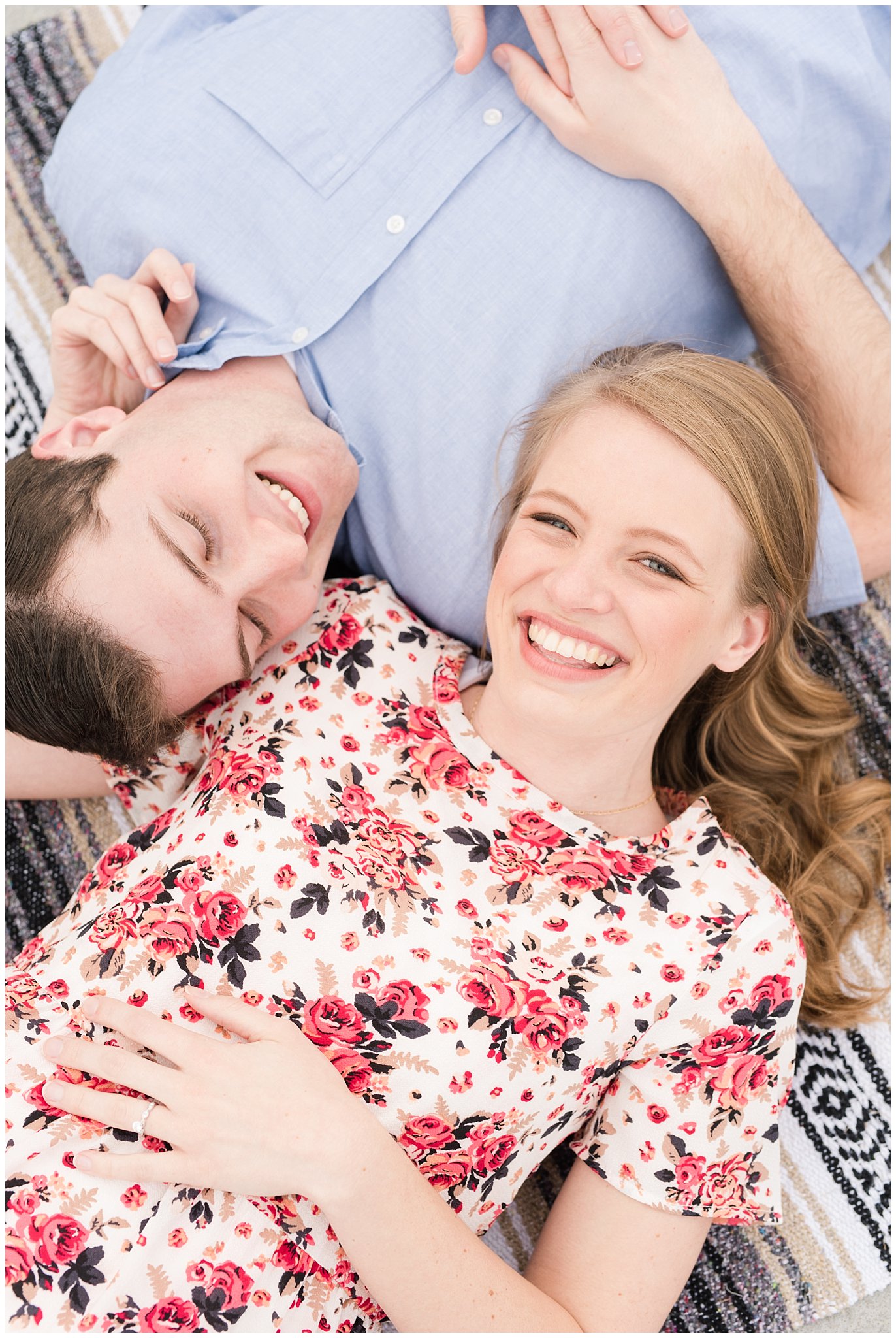 Couple laying down on rooftop | Downtown Salt Lake and Ensign Peak Engagement | Utah Wedding Photographers | Jessie and Dallin Photography