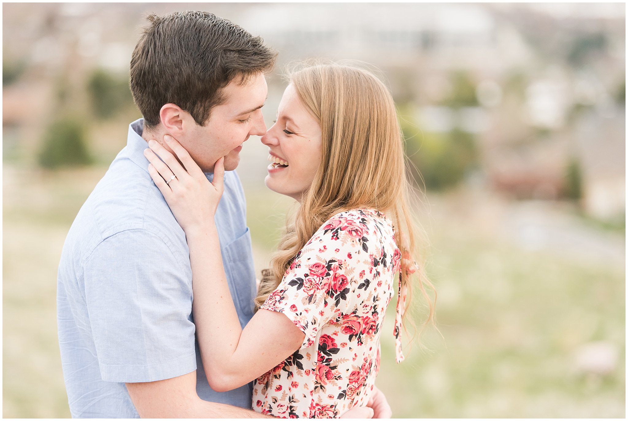 Couple on mountain overlooking city | Downtown Salt Lake and Ensign Peak Engagement | Utah Wedding Photographers | Jessie and Dallin Photography