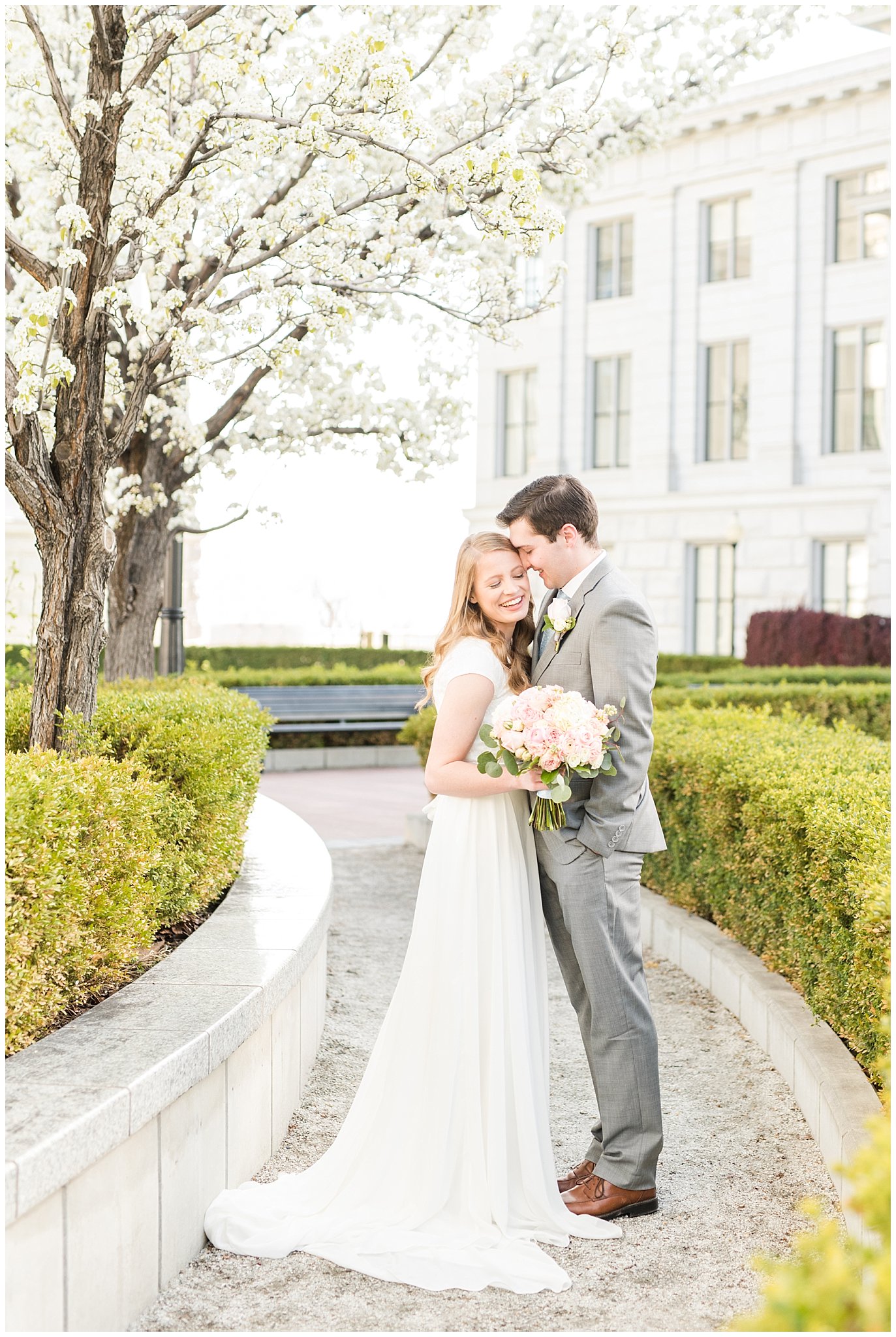 Bride with blush bouquet and groom with grey suit in the blossoms | Utah State Capitol Blossoms Formal Session | Salt Lake Wedding Photographers | Jessie and Dallin Photography