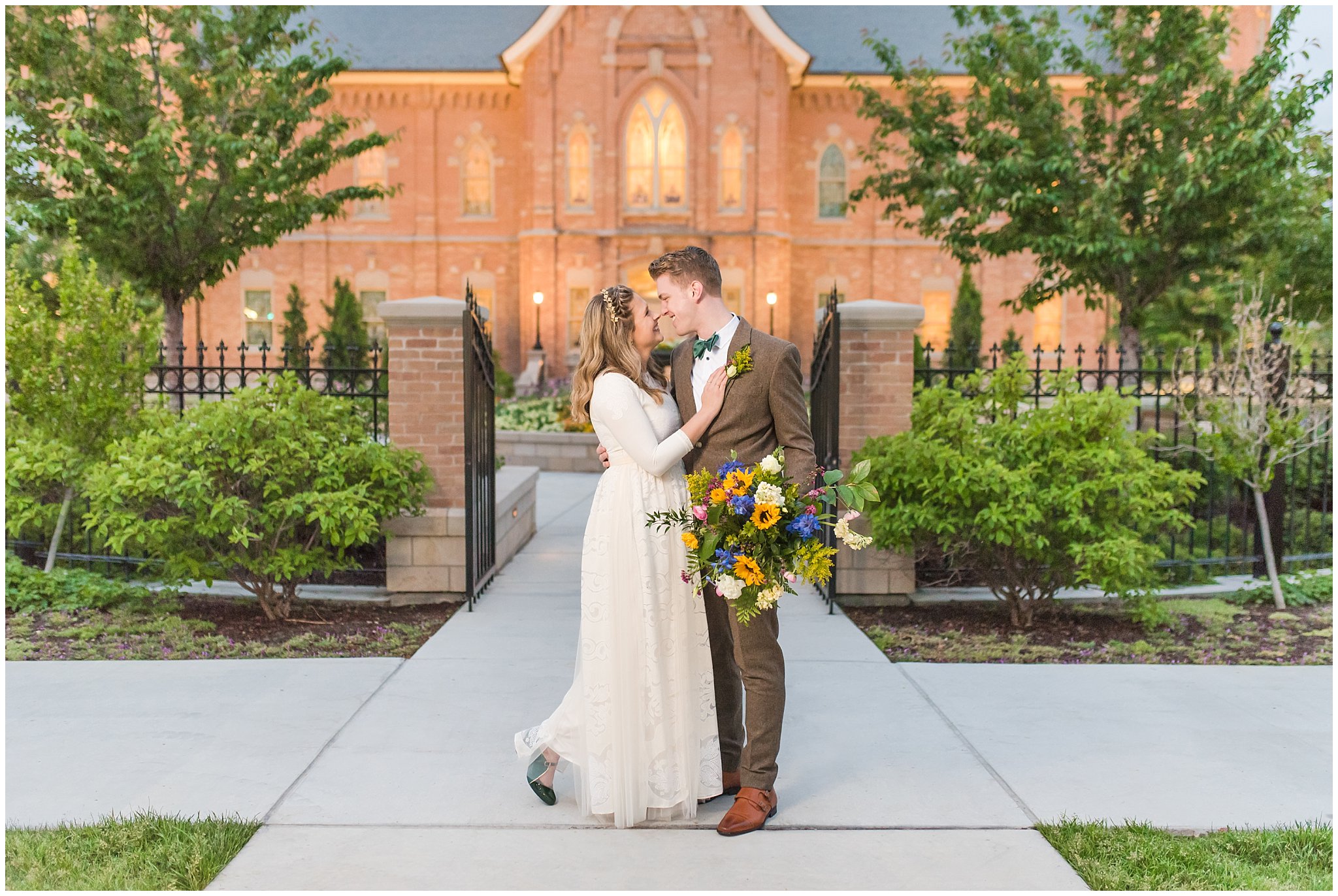 Bride wearing flowy dress and groom wearing tweed suit and green bow tie for vintage inspired wedding attire | Provo City Center Temple Romantic portraits at night | Provo City Center Temple Spring Formal Session | Jessie and Dallin Photography